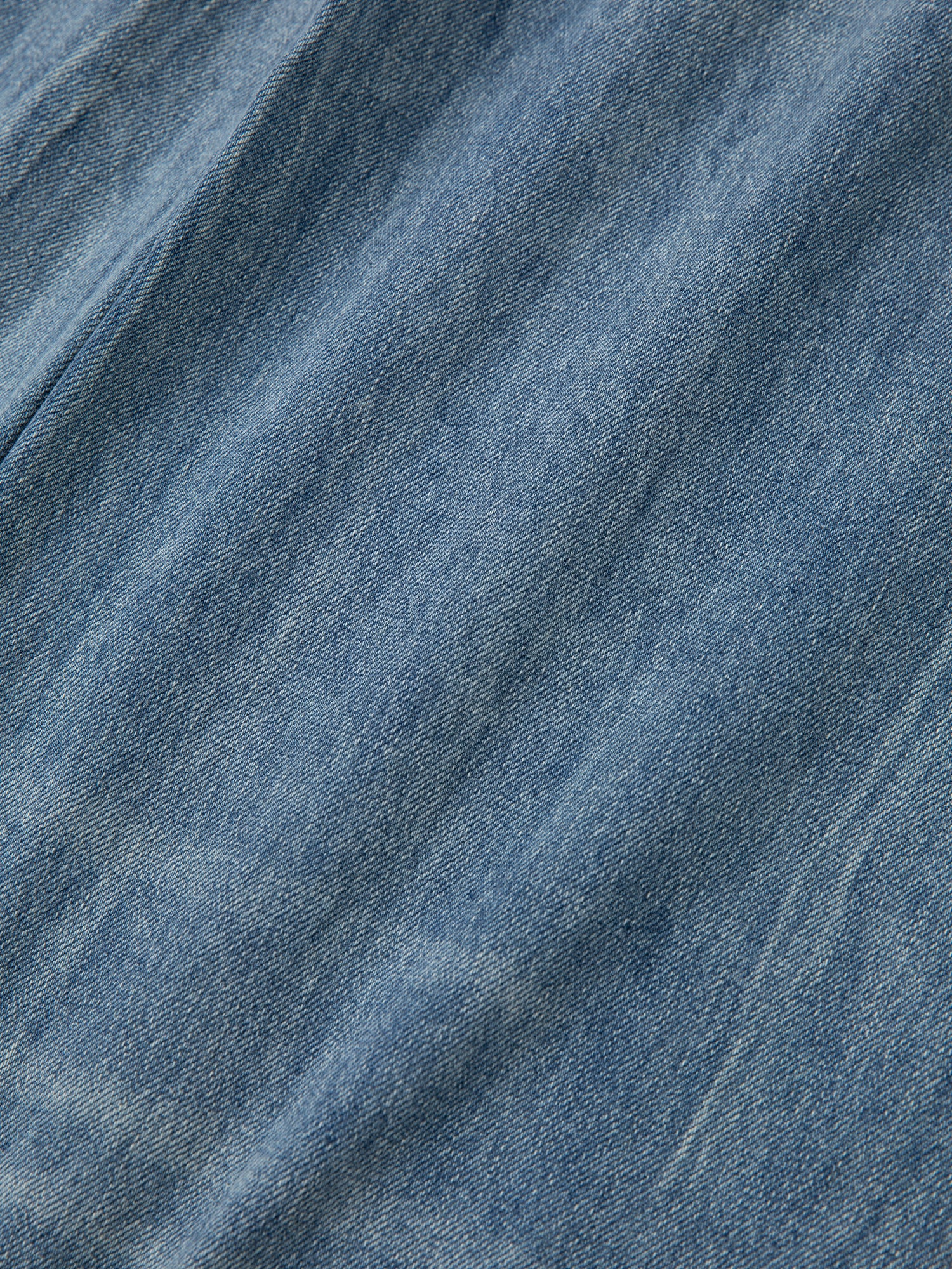 A close up of Found's Lacy Baggy Jeans in a vintage blue wash denim fabric.