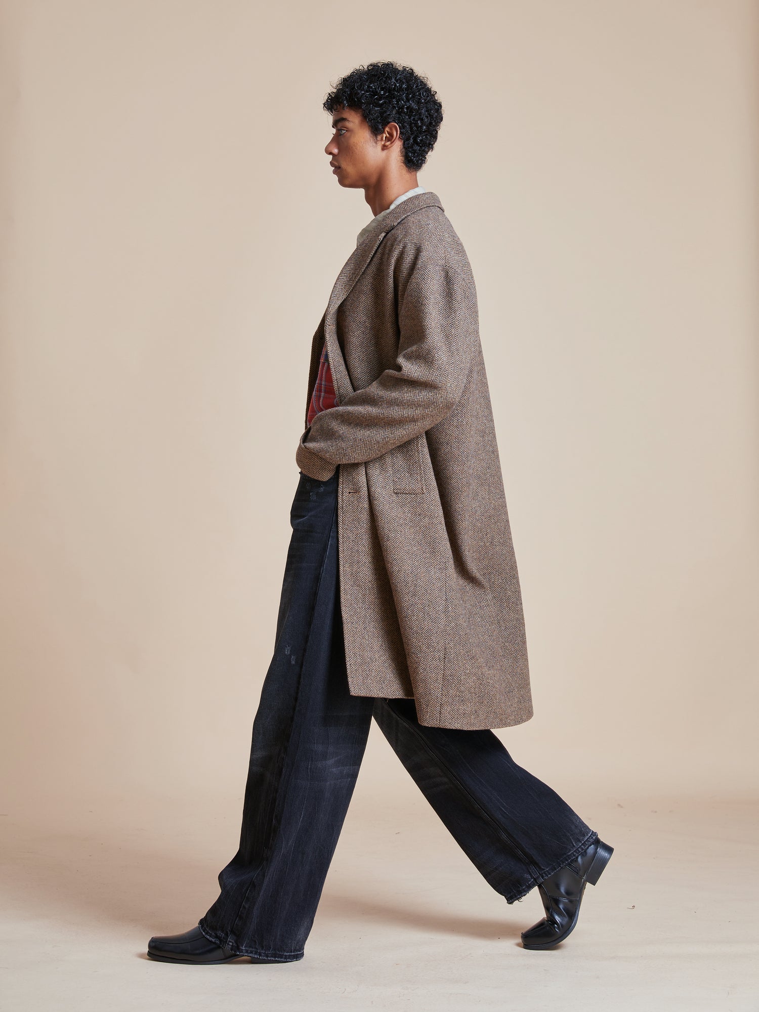 A woman wearing an Elm Tweed Long Top Coat from Found brand.