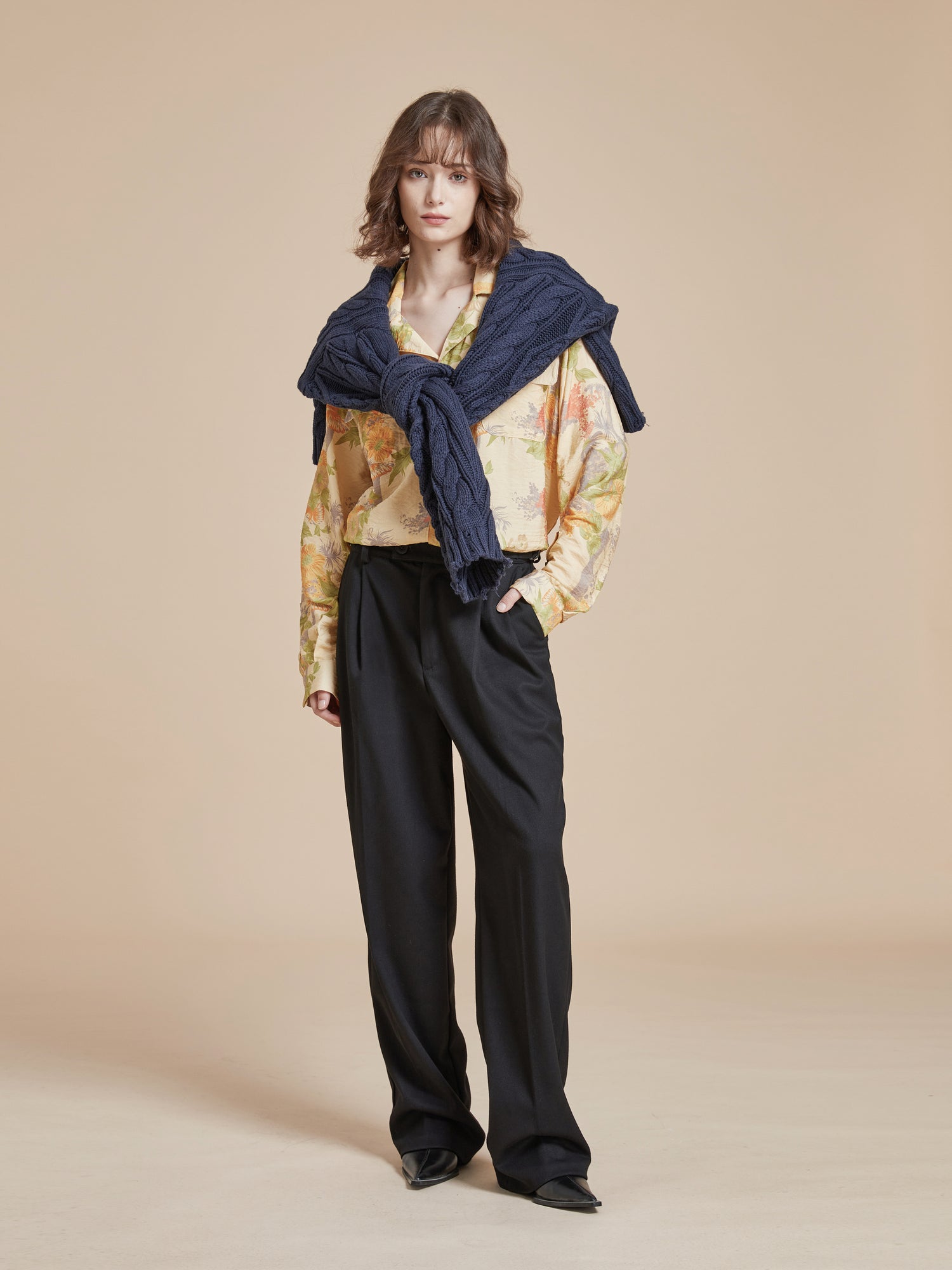 A model wearing black trousers and a blue scarf showcasing the Meraj Vase Pot Long Sleeve Camp Shirt from Found.
