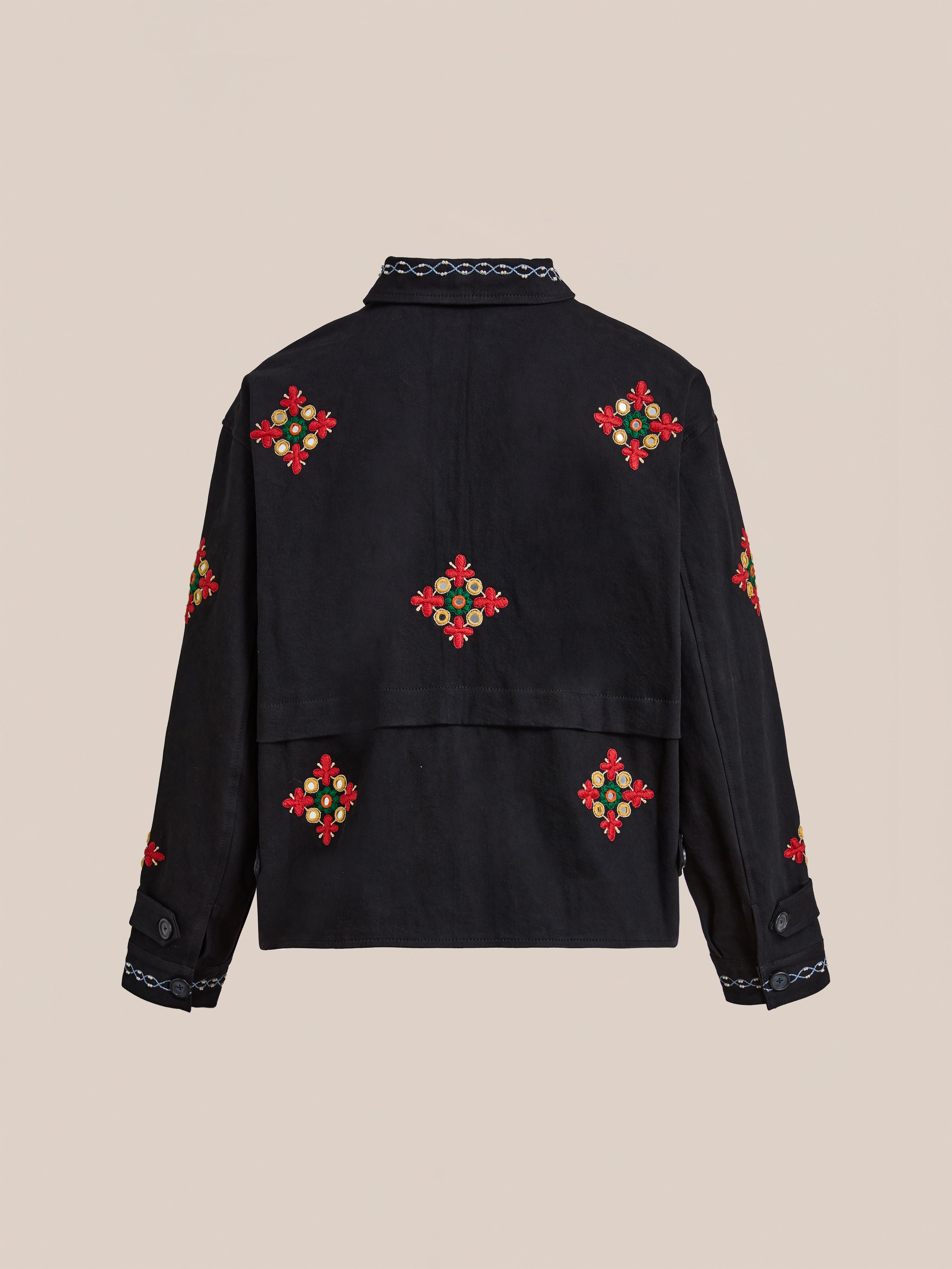 The Mirror Ornament Hand Embroidered Work Jacket by Found features black cotton with red and green floral Aari embroidery on the back, sleeves, and collar, shown against a plain beige background.