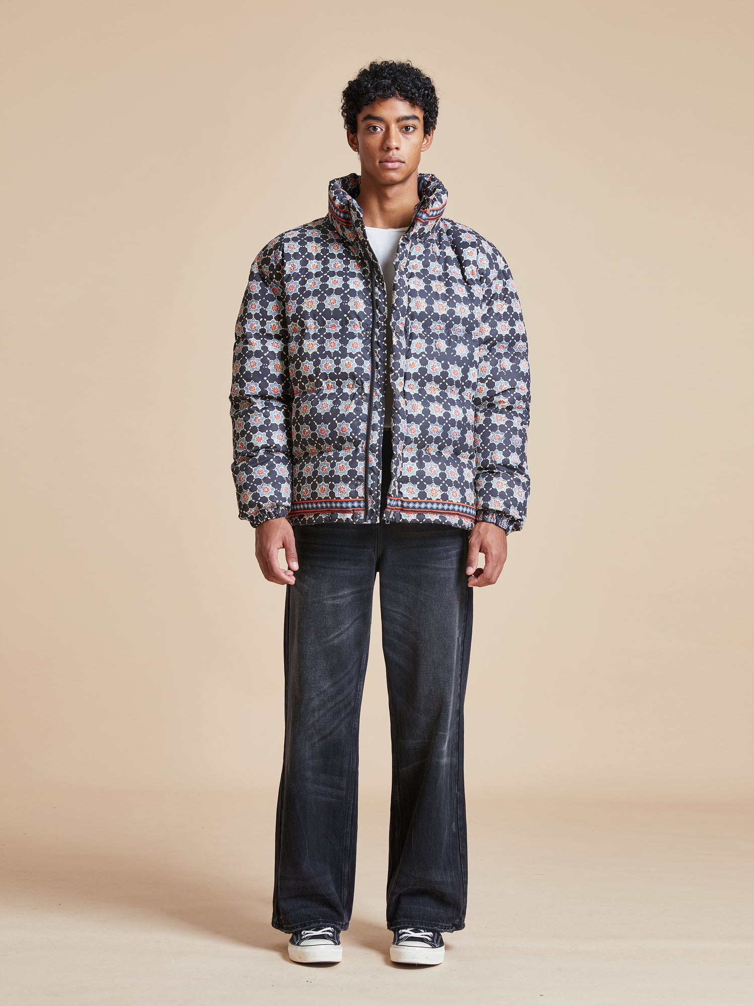 A man wearing a black Found Ajrak Block Puffer Jacket.