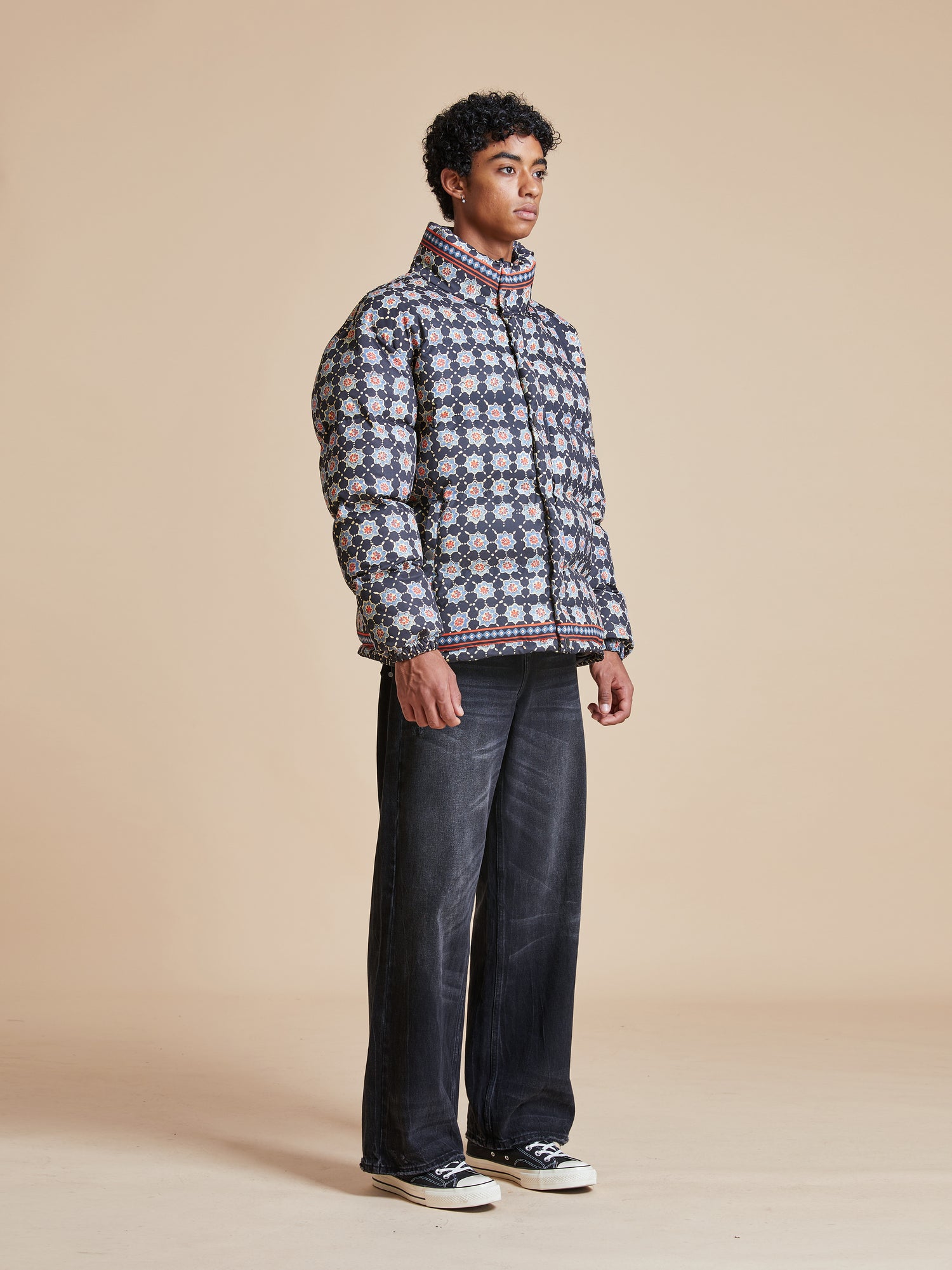 A man wearing a blue and white Found Ajrak Block Puffer Jacket.