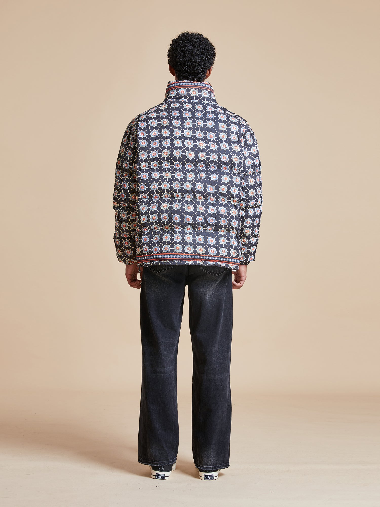A man wearing a Found Ajrak Block Puffer Jacket.