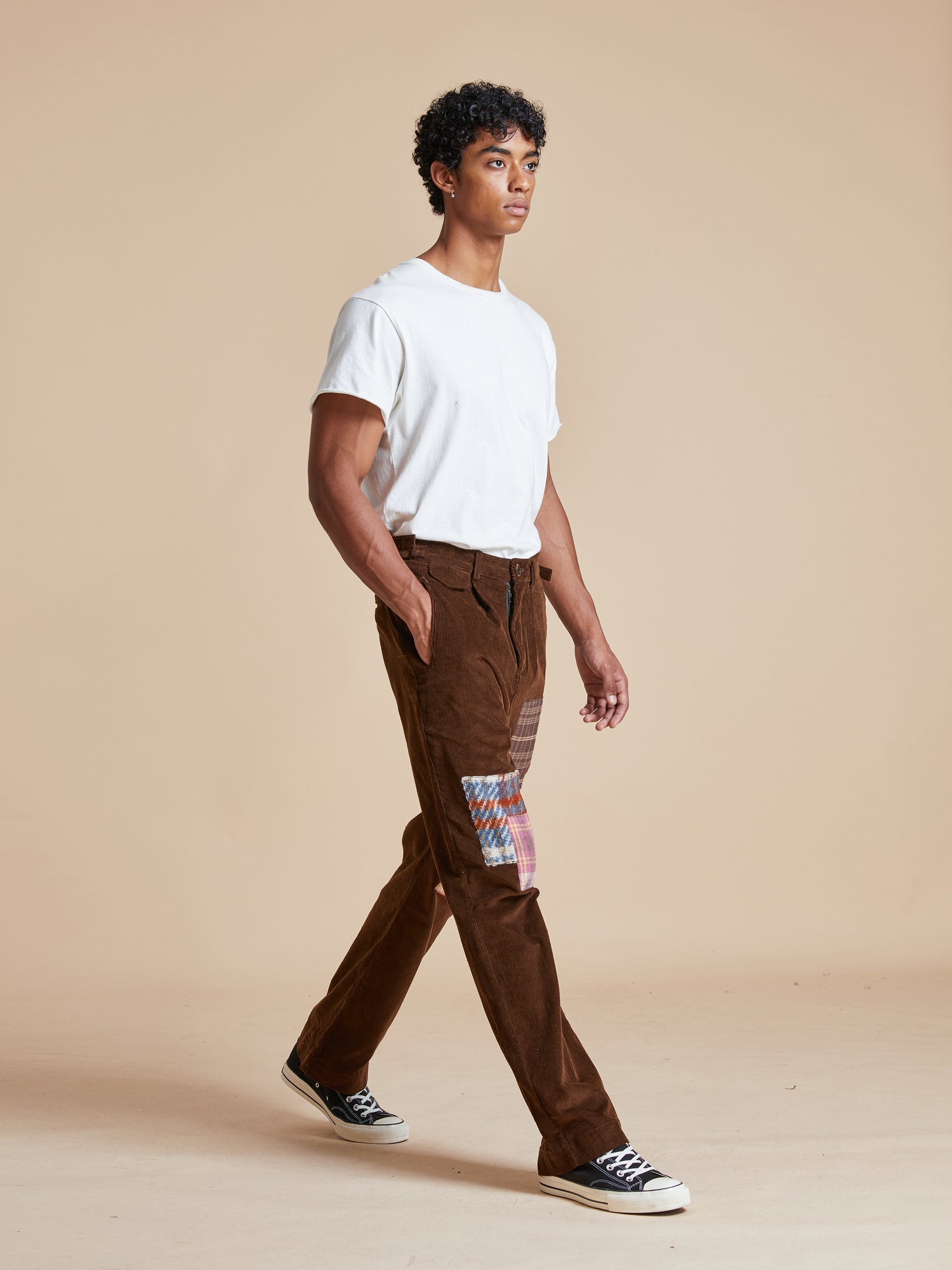 A man wearing Multi-Plaid Patch Corduroy Pants by Found.