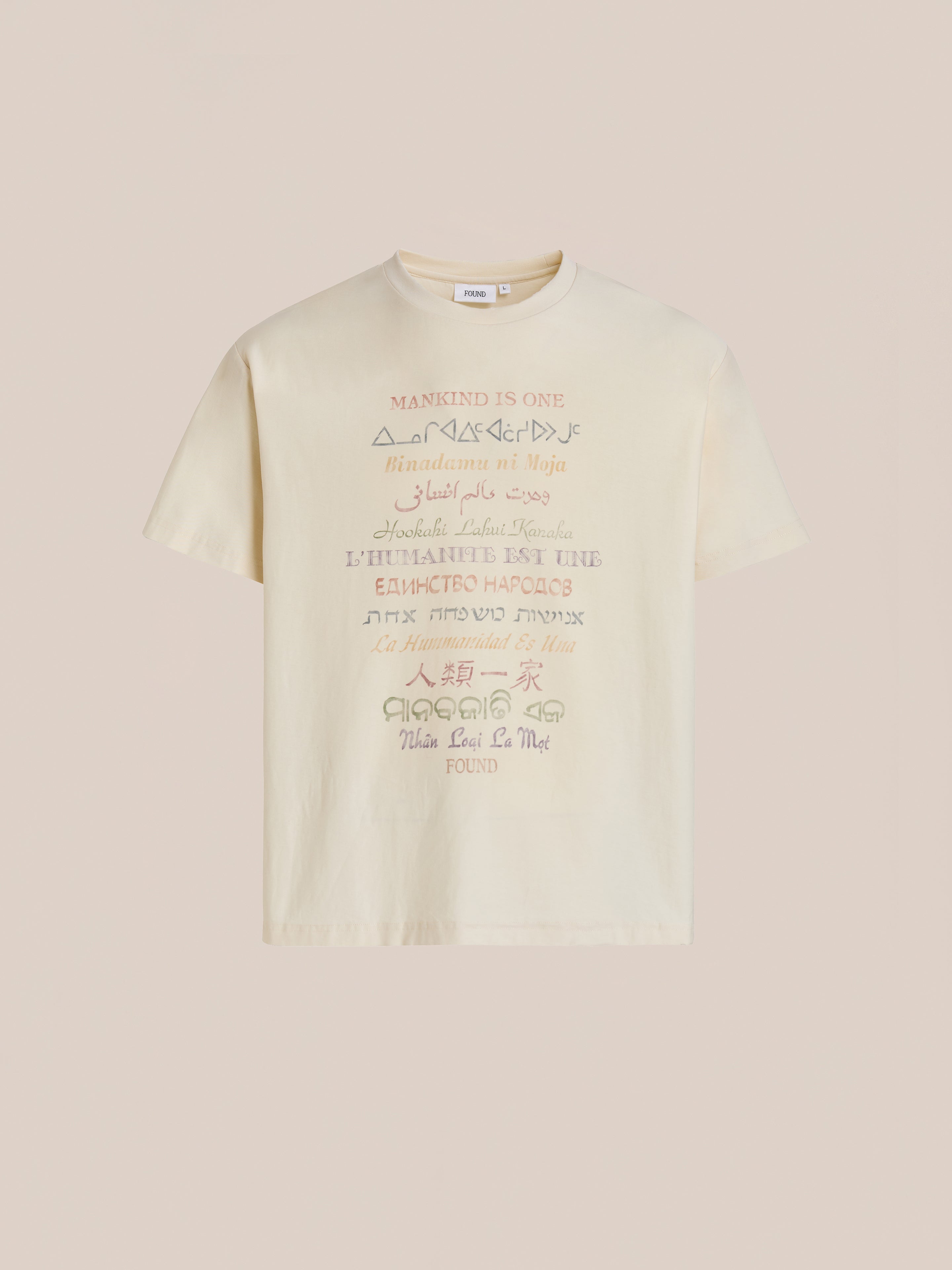 The FOUND One Humanity Tee is a beige vintage cotton unisex t-shirt featuring "MANKIND IS ONE" and its translations in diverse fonts and colors, celebrating unity in style.