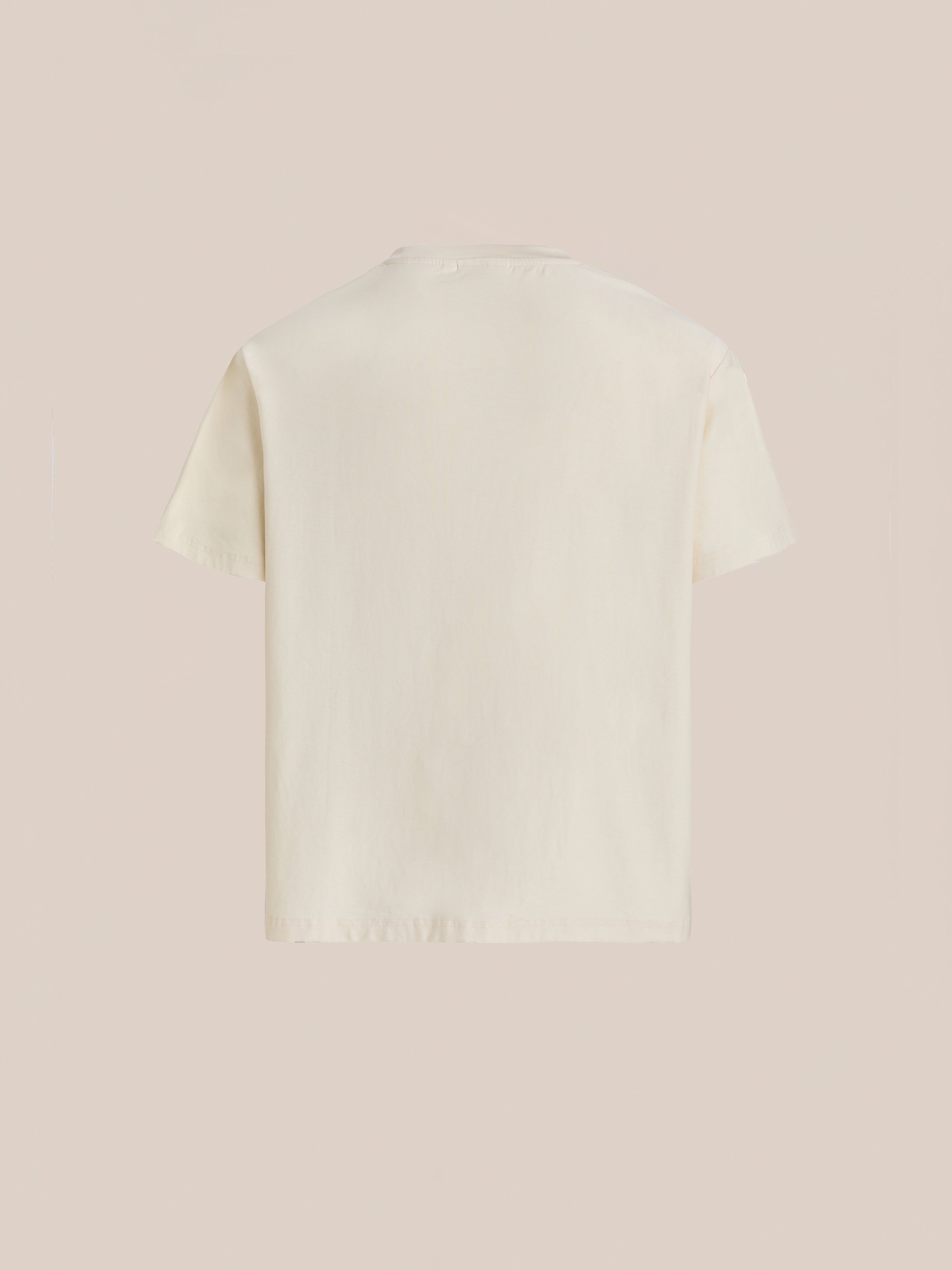 The off-white One World Family Tee by FOUND, shown from the back against a light beige background, subtly represents multiculturalism and unity.