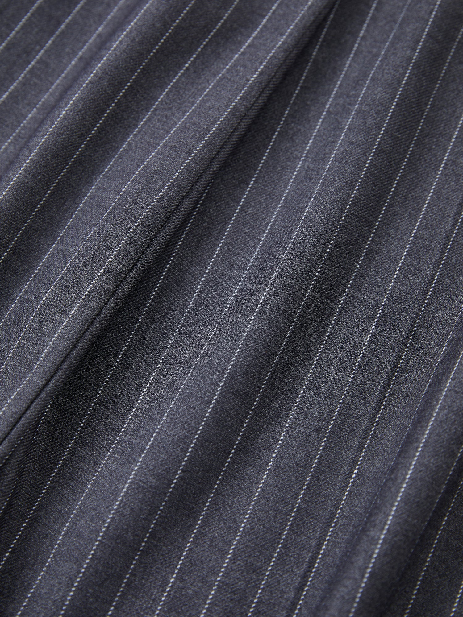 A close up of Found Pinstripe Pleated Trousers fabric.