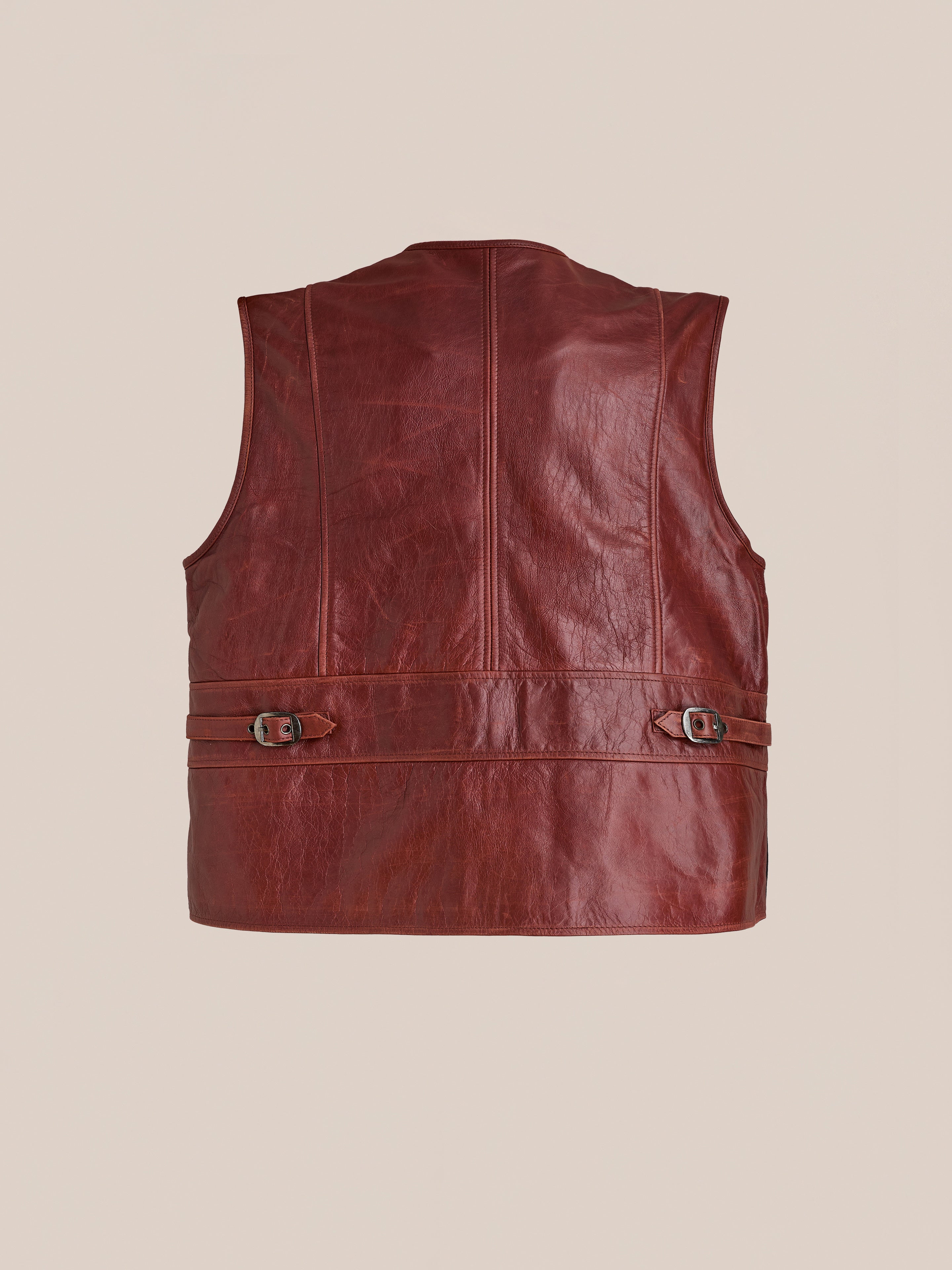 Back view of Found’s Fur Western Leather Vest, a sleeveless brown leather design with adjustable buckled straps on both sides, shown against a plain background.