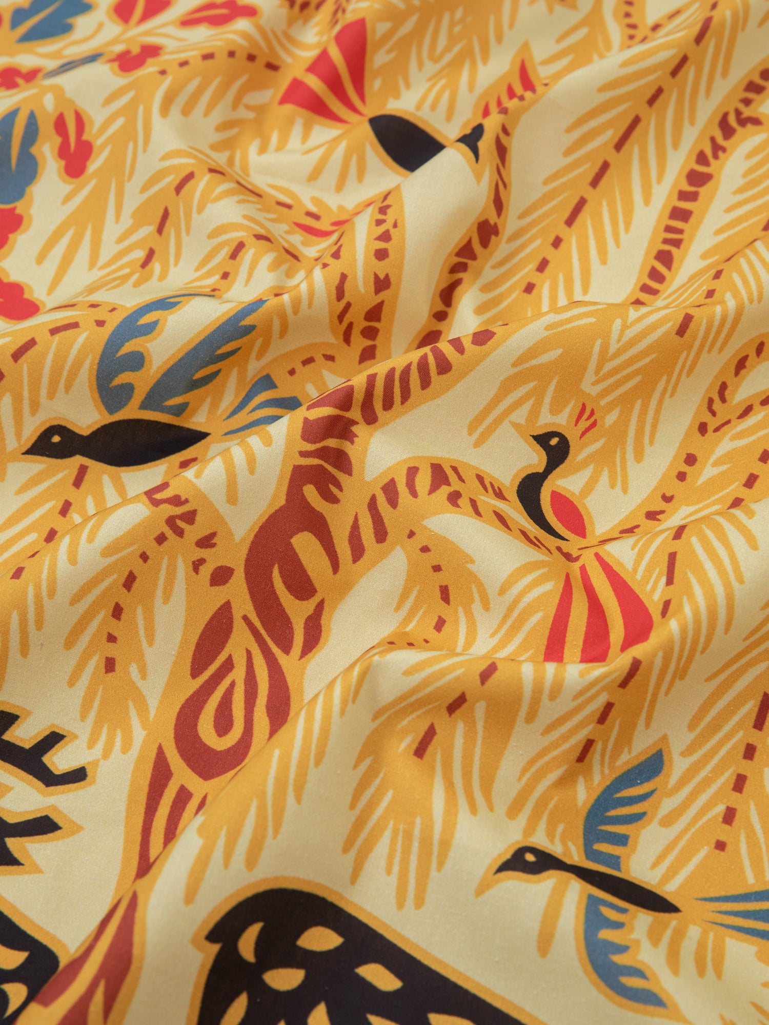 A pre-order fabric featuring Phulkari artwork of birds and trees, designed as a Found Rainforest Bandana.