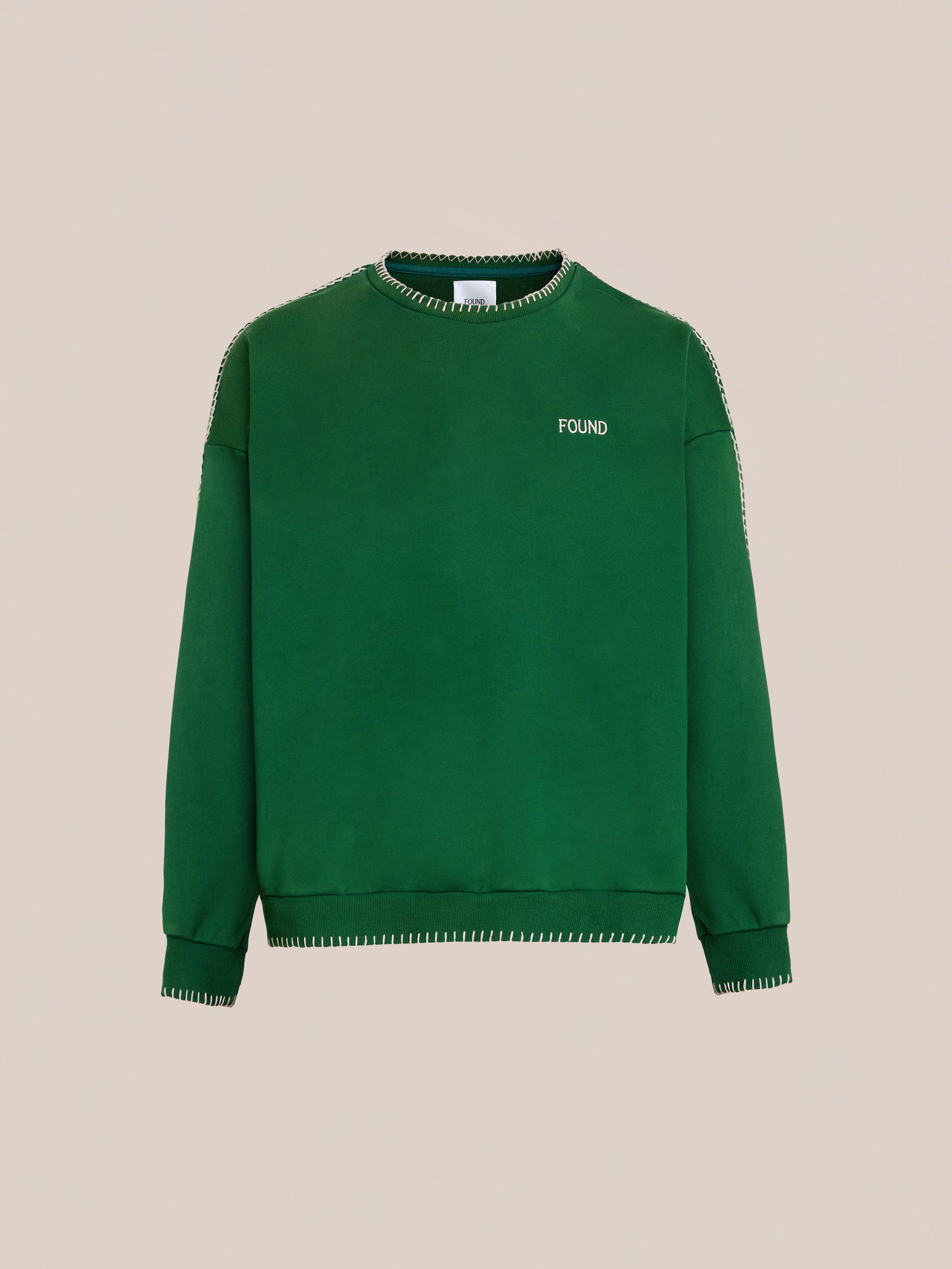 The FOUND Stitched Border Distressed Crewneck is crafted from soft French terry cotton, featuring white stitched borders and "FOUND" embroidery on the upper left chest for a classic touch.