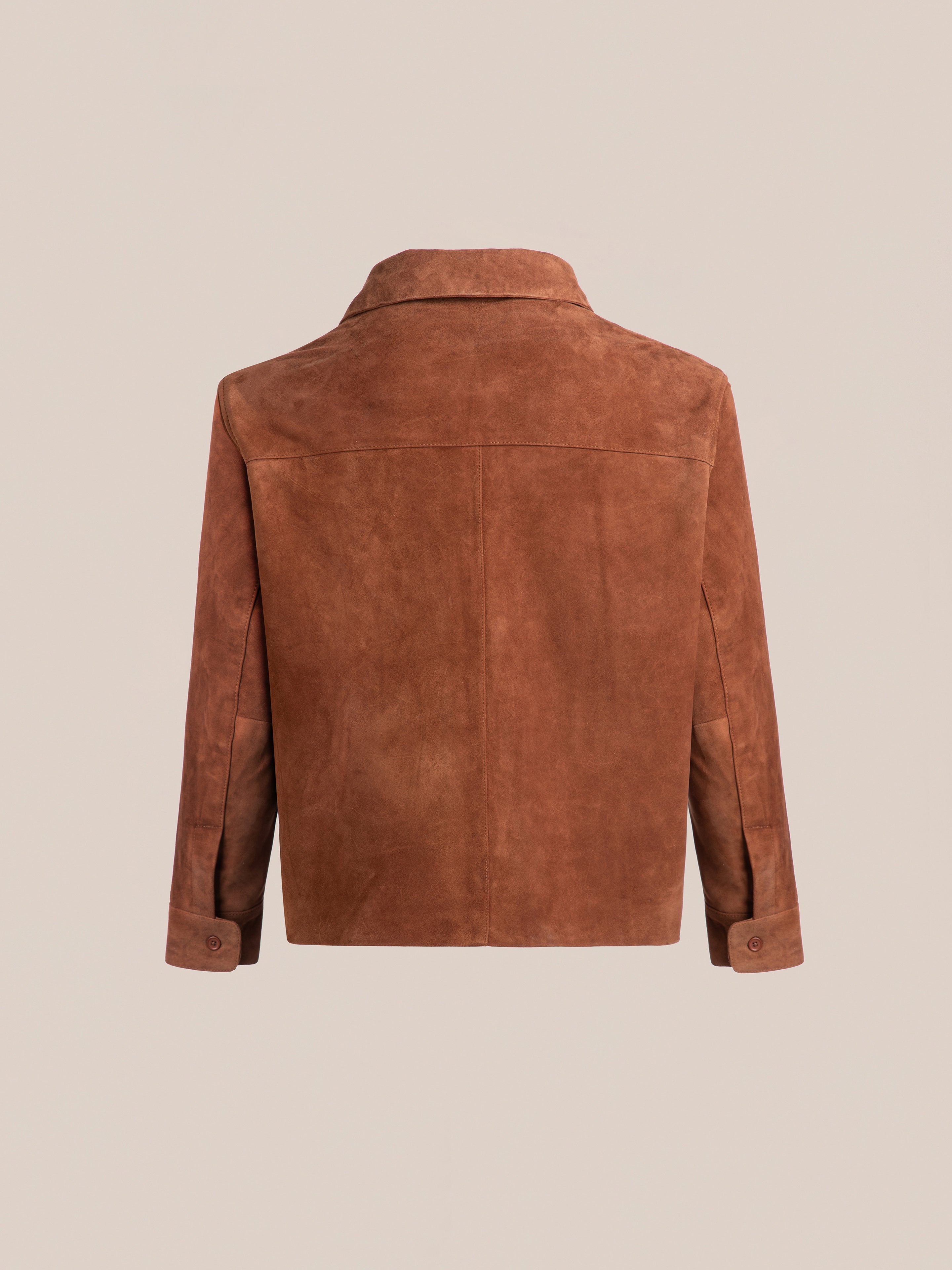 The FOUND Suede Leather Camp Shirt is a brown unisex relaxed-fit jacket shown from the back, with a straight yoke, collar, long sleeves, and buttoned cuffs set against a plain background.
