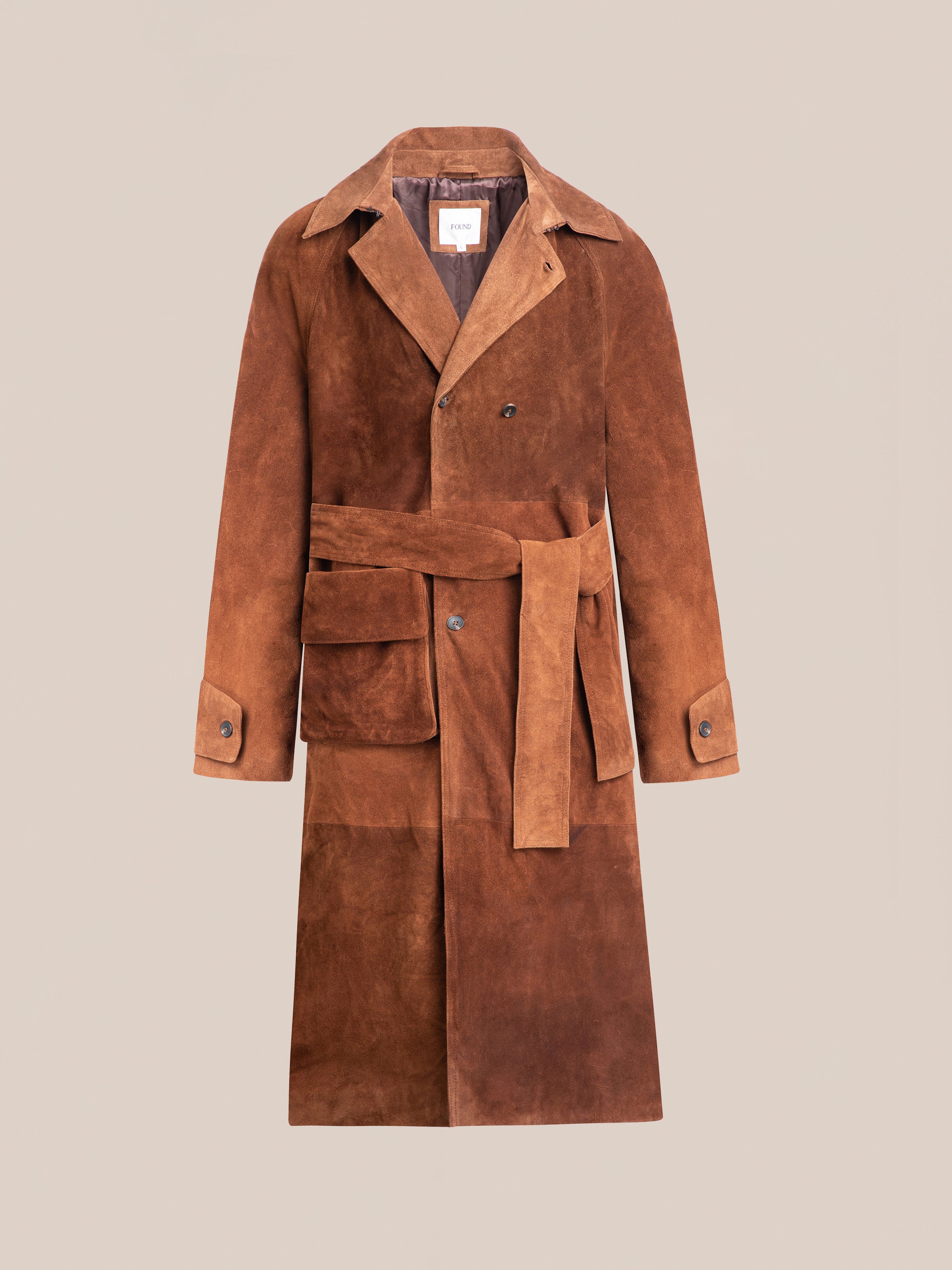 The FOUND Suede Leather Trench Coat offers a luxurious mid-weight cow suede design, featuring a relaxed fit, stylish belt, and buttoned cuffs on beige.