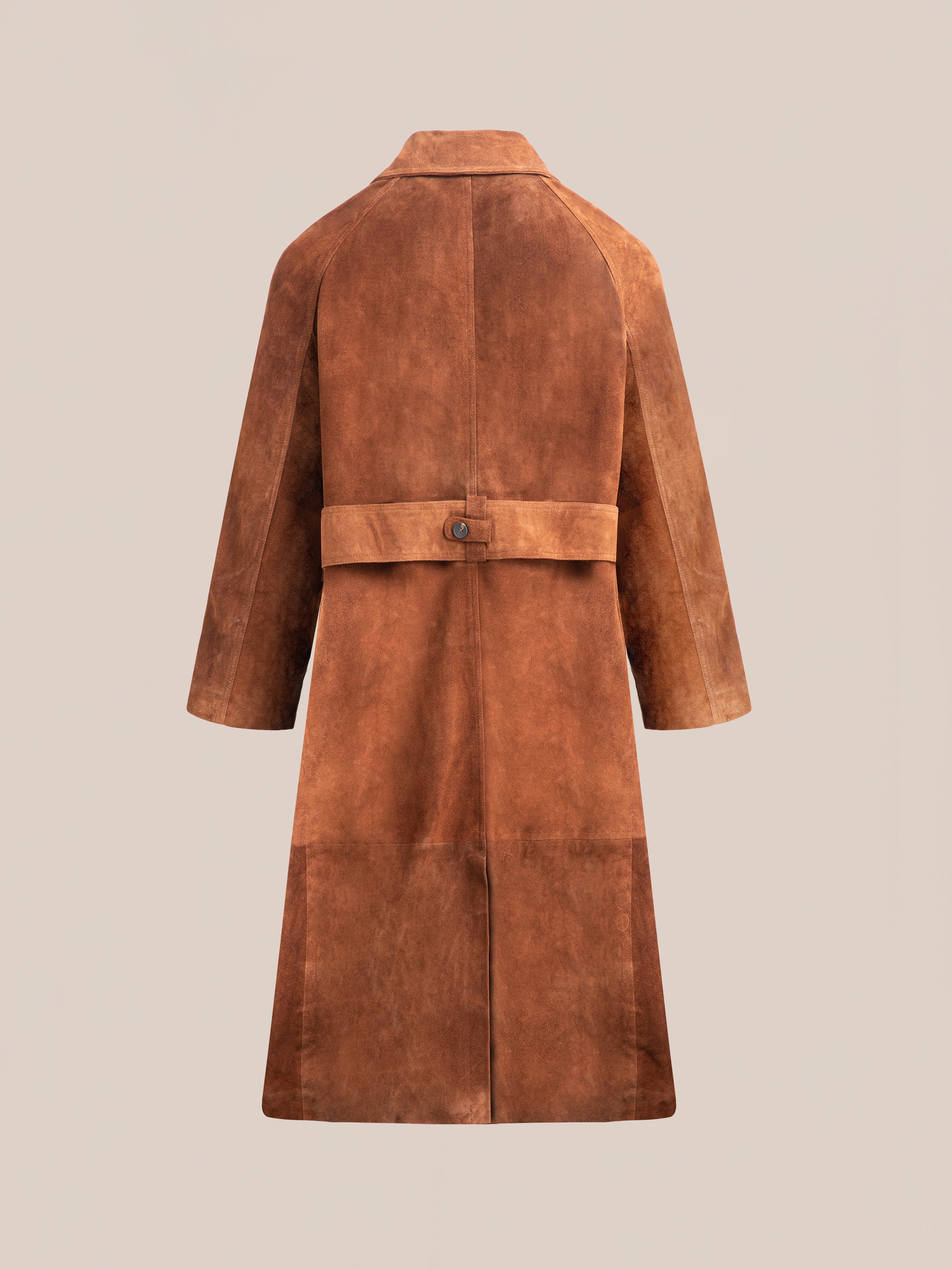 The Suede Leather Trench Coat by FOUND is a unisex, ethically crafted piece featuring a back belt detail, elegantly displayed against a plain background.