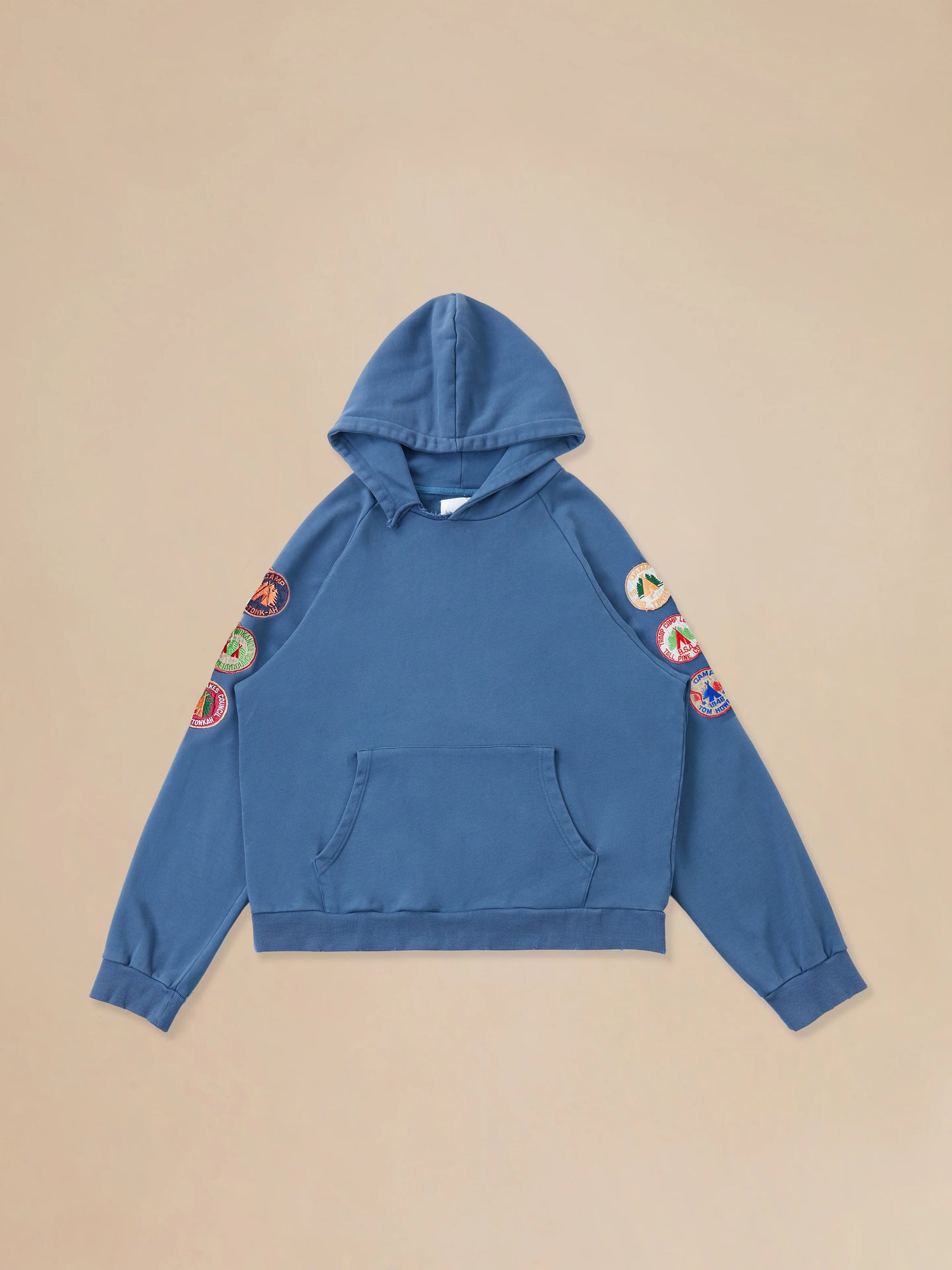 A vintage-inspired Found Timber Campground Hoodie with colorful patches and distressed details.