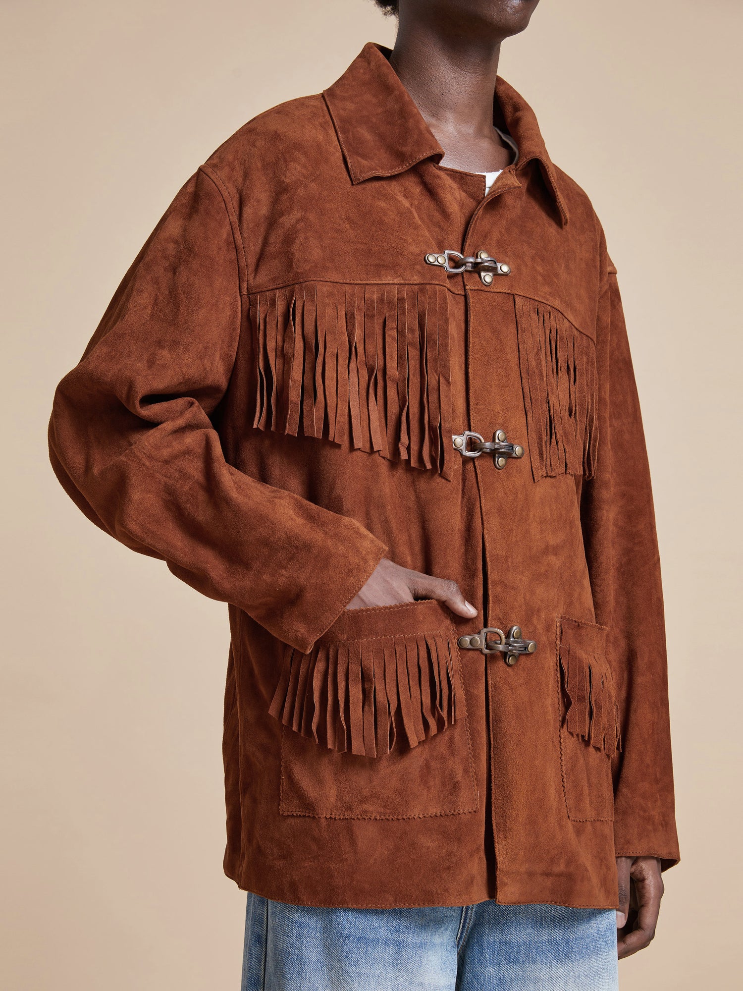 A man donning a Found Tobacco Fringe Suede Buckle Jacket.