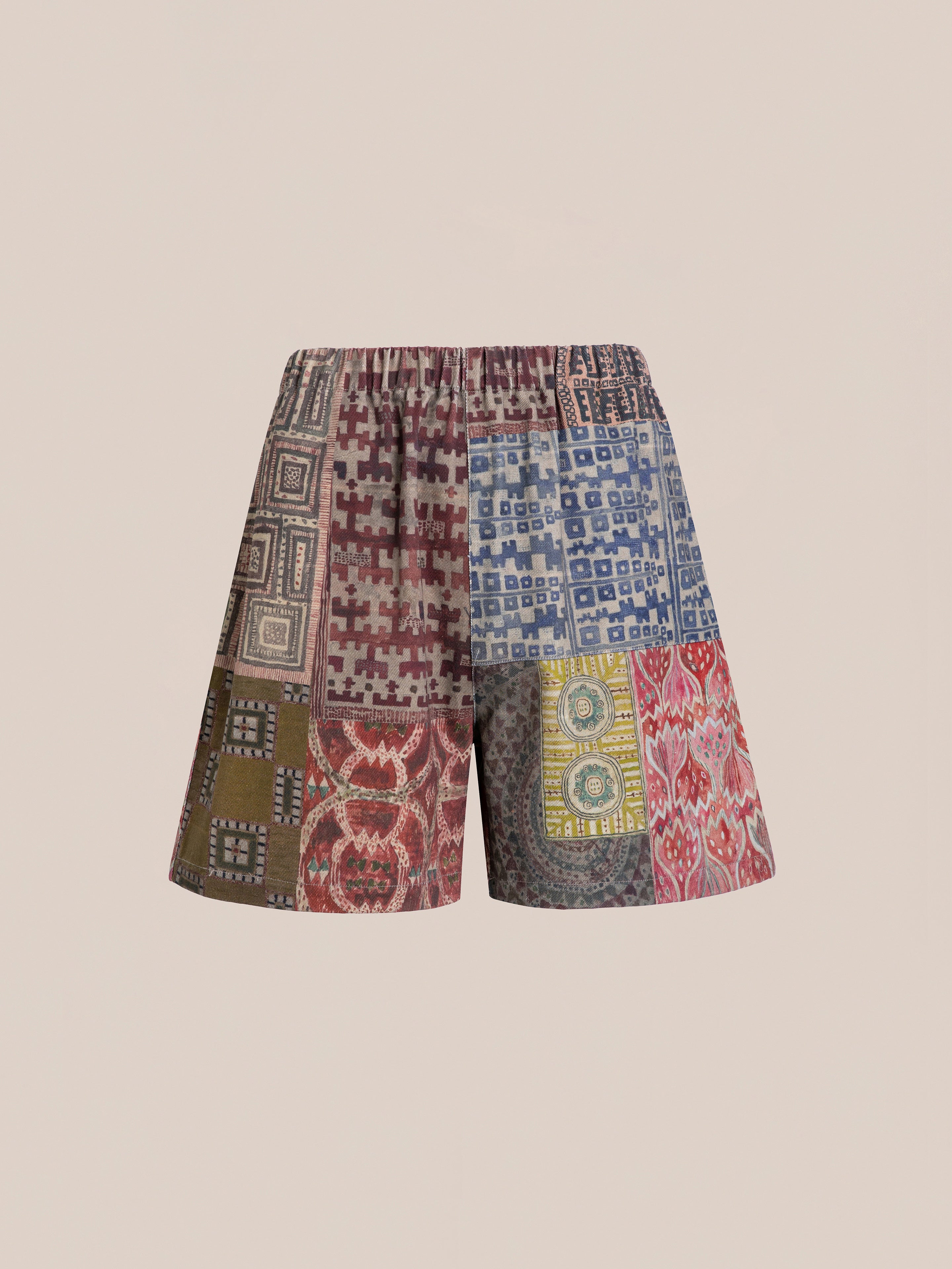 FOUND's Watercolor Mosaic Work Shorts feature multicolored geometric patterns on a beige background, offering a unisex relaxed fit with vintage-inspired designs.