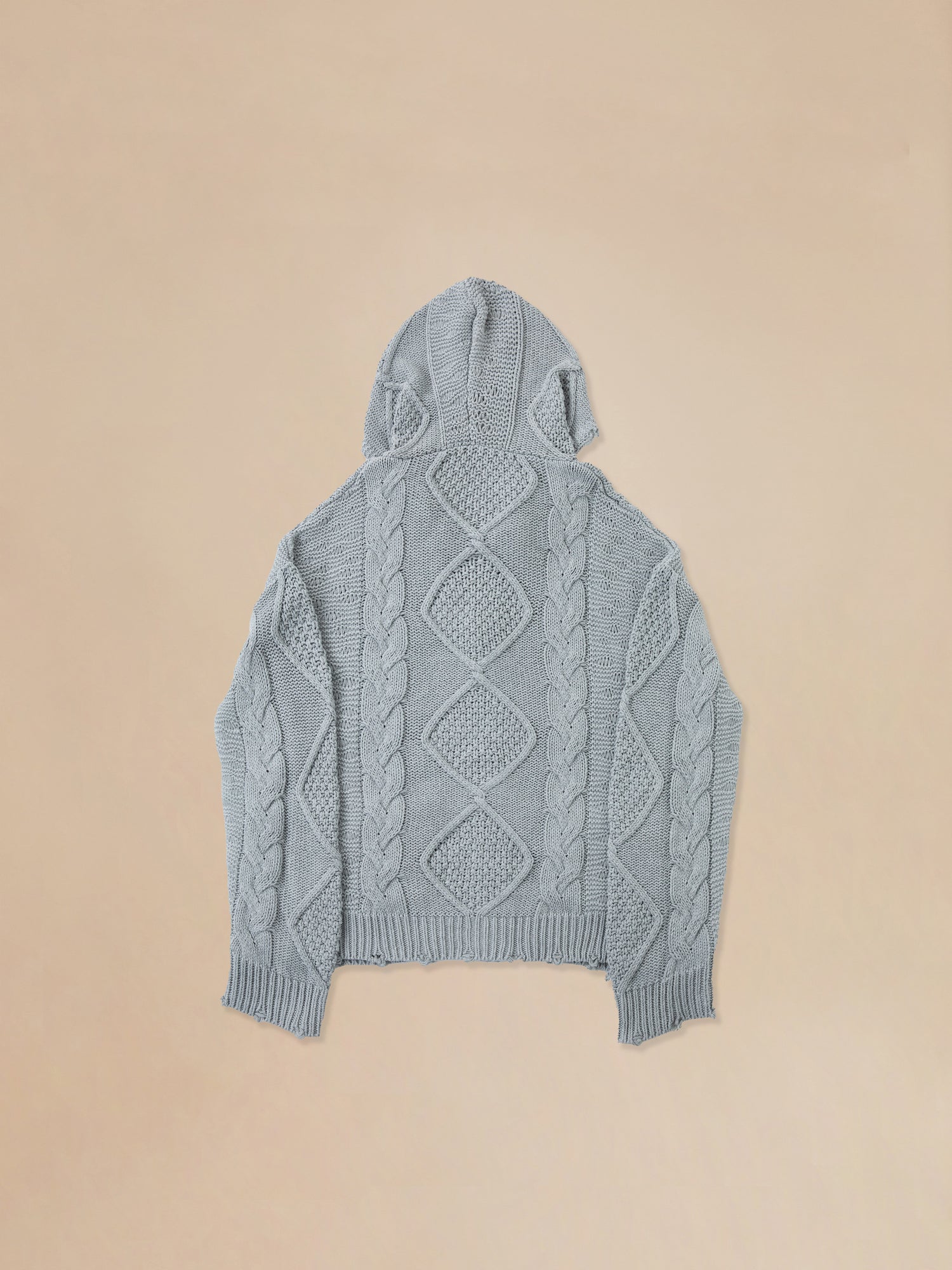 The back of a Found Zip Up Distressed Cable Knit Hoodie, providing comfort and warmth.