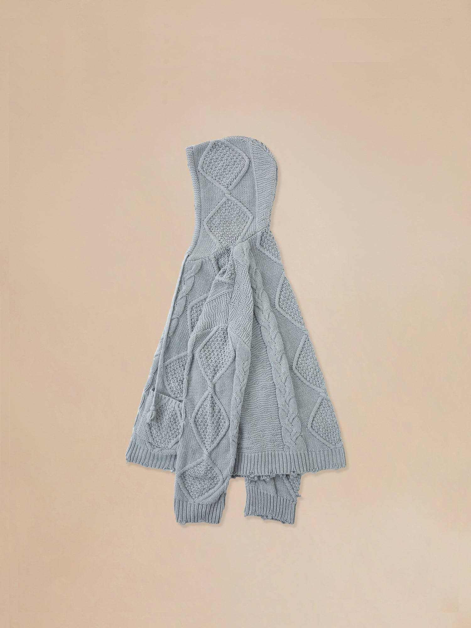 A warm Zip Up Distressed Cable Knit Hoodie by Found on a beige background.