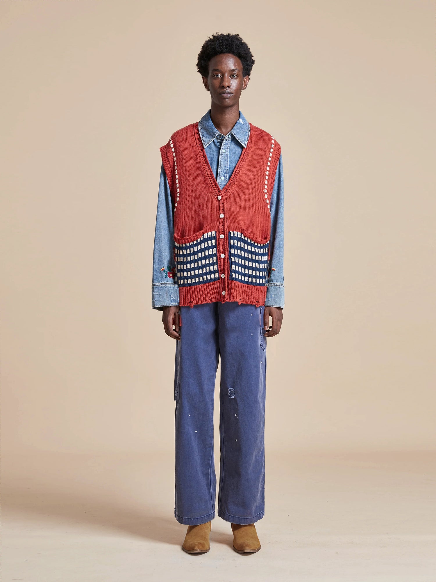 The model is wearing a red Found Homestead Check Sweater Knit Vest.