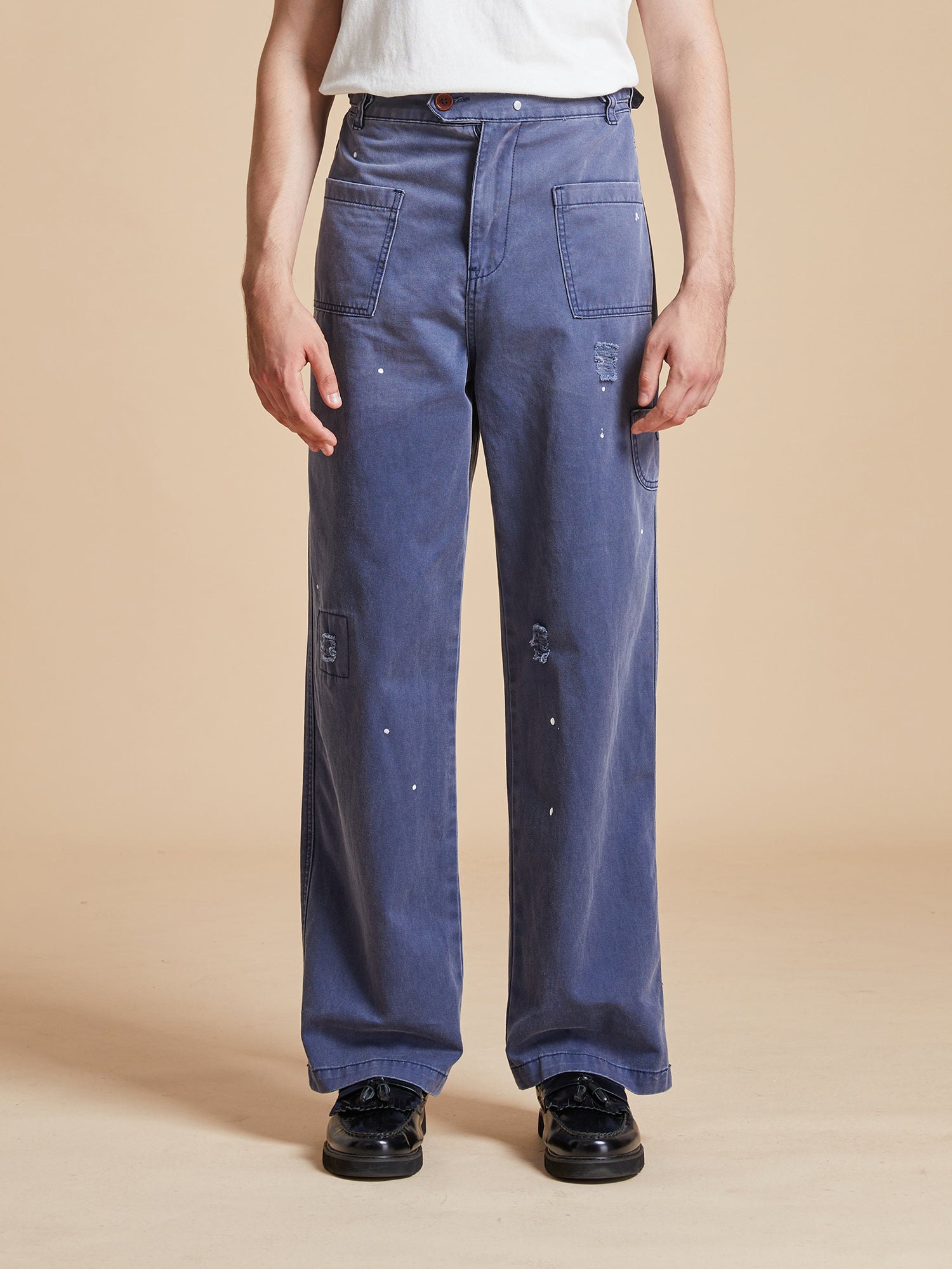 A man wearing classic painter uniforms with Found's River Painters Chore Pants and a white t-shirt.