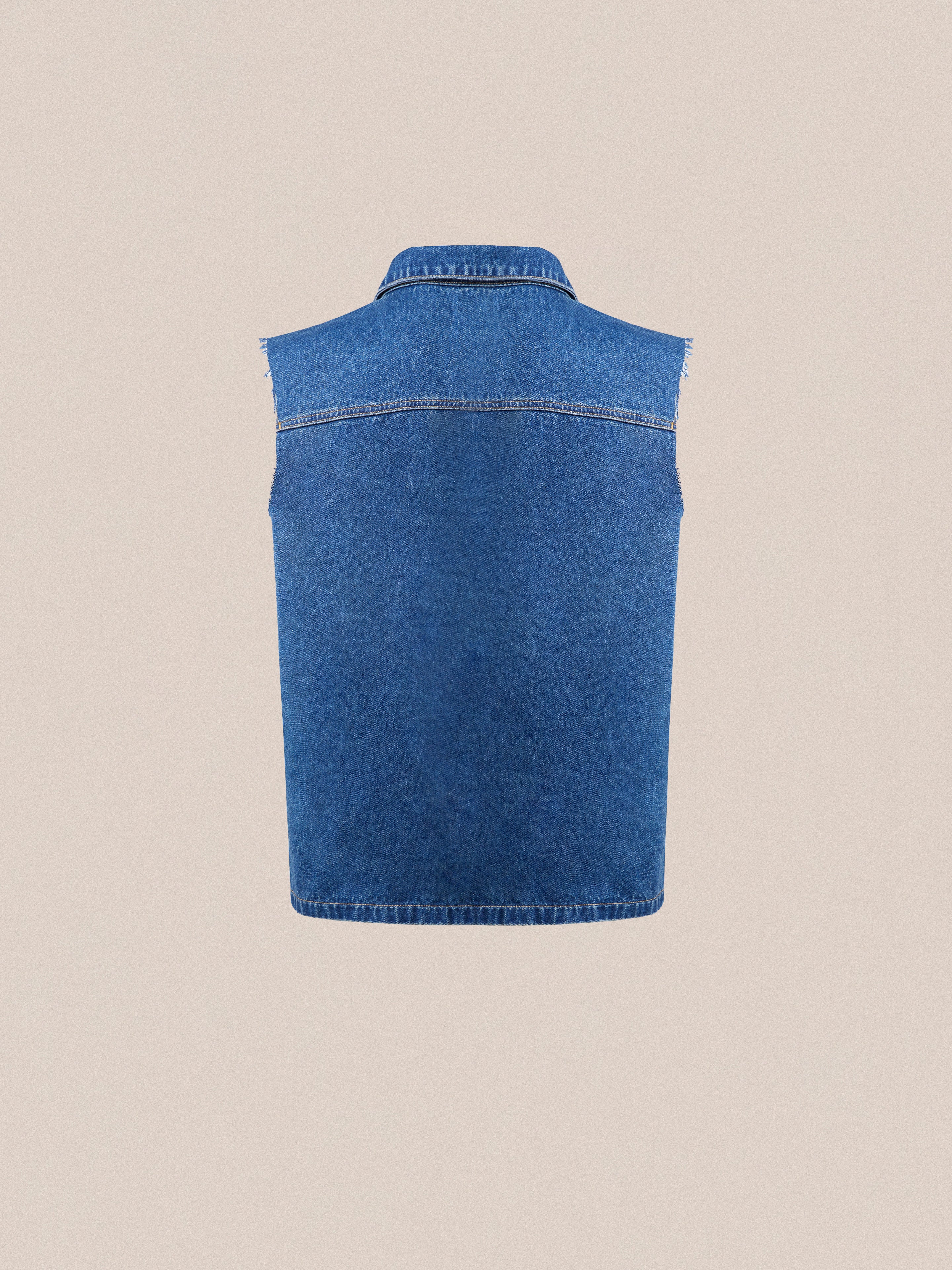 A vintage-inspired, sleeveless Raw Cut Patch Mechanic Denim Vest by Found displayed against a plain beige background.