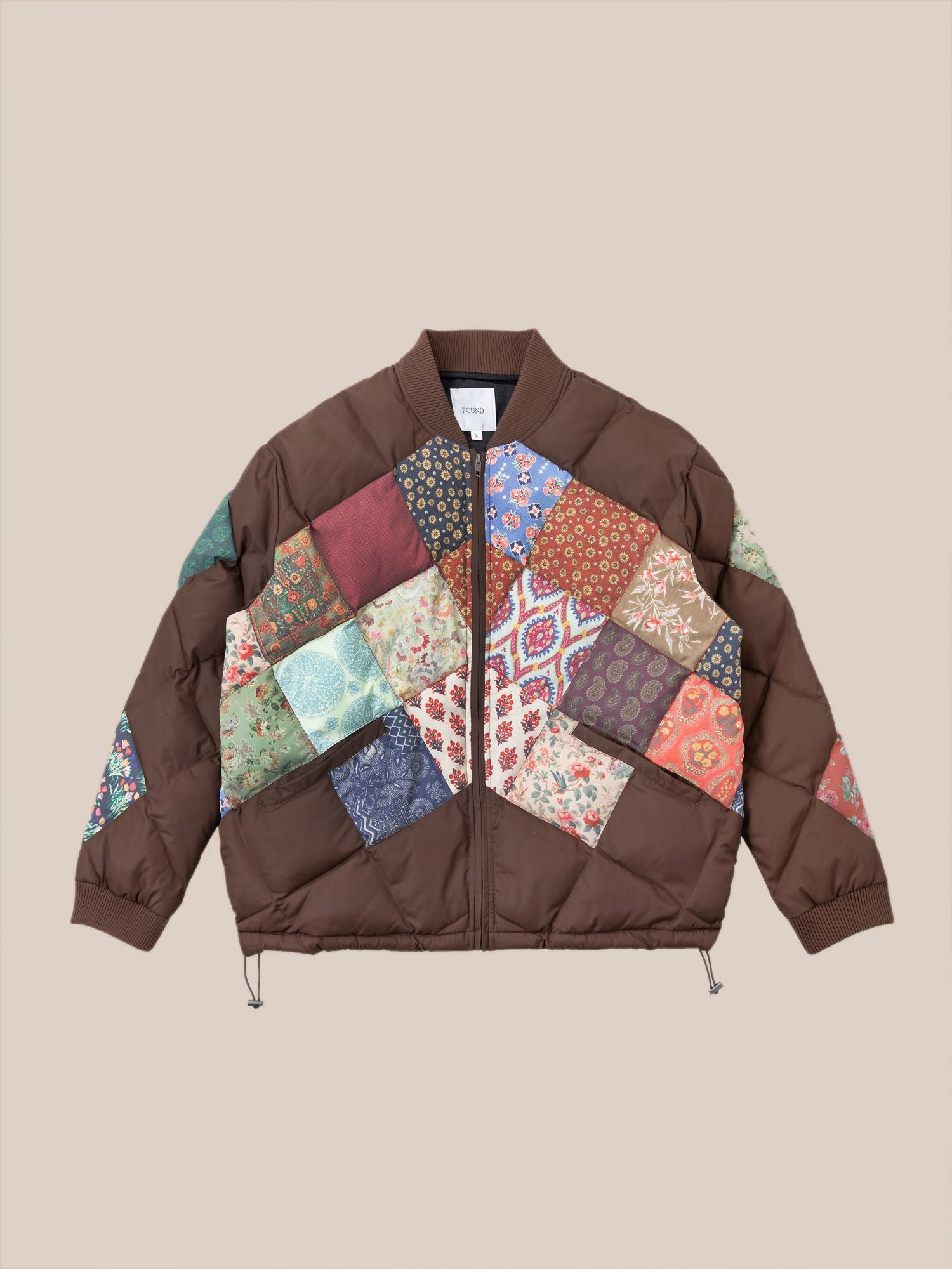 A brown Diamond Quilt Patchwork Jacket by Found featuring a colorful patchwork pattern with various floral and geometric designs, reminiscent of traditional South Asian prints.