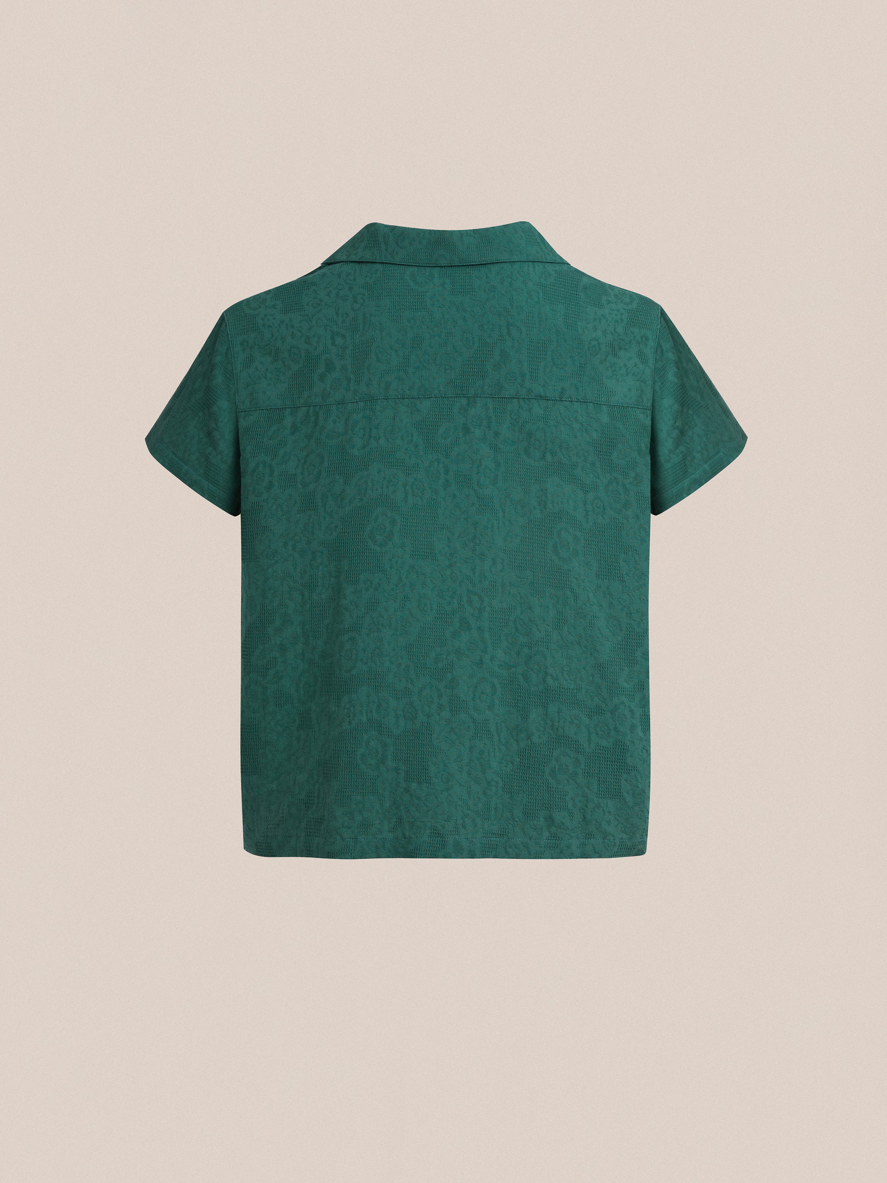 The back view of a green Found Mount Camp Shirt with a short sleeve and lace detailing.