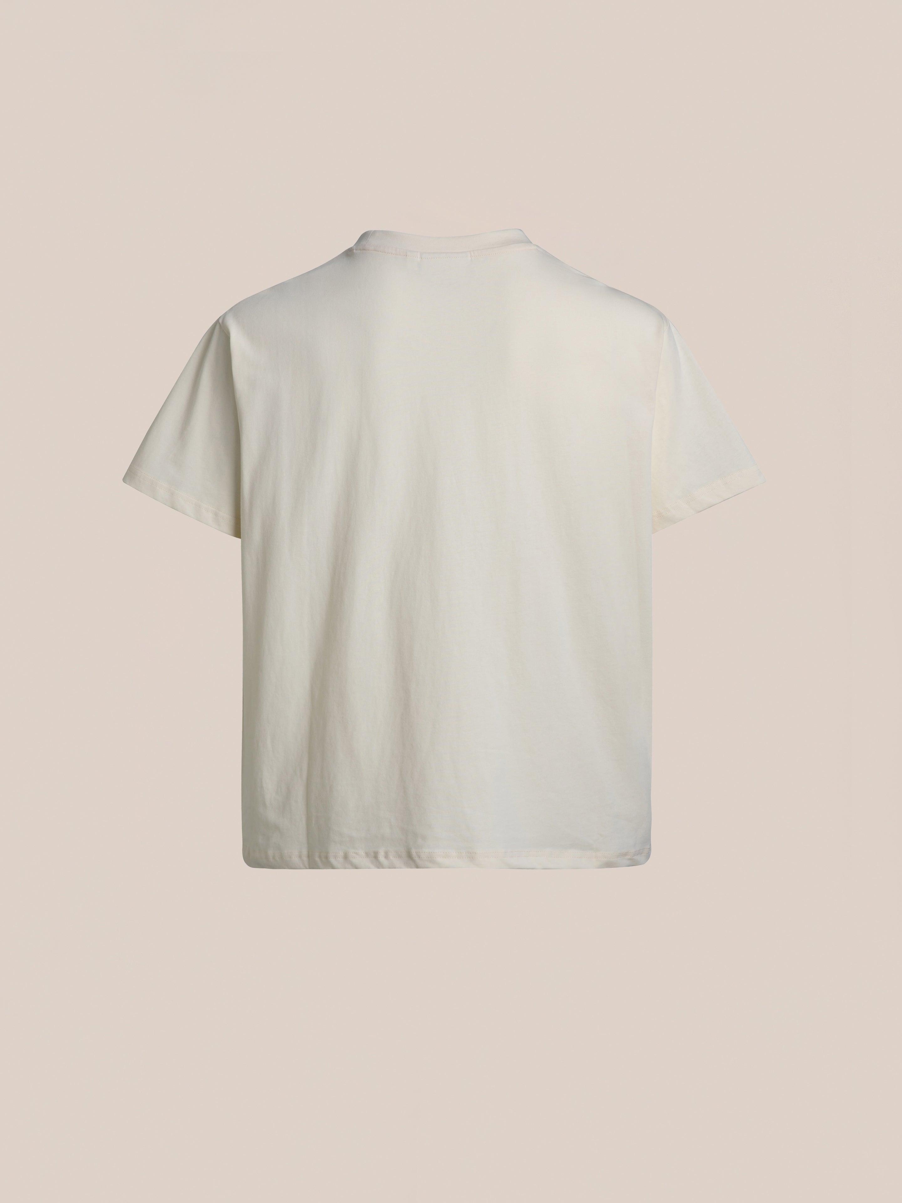 A back-view image of the Patchwork Tee by FOUND, set against a beige background.
