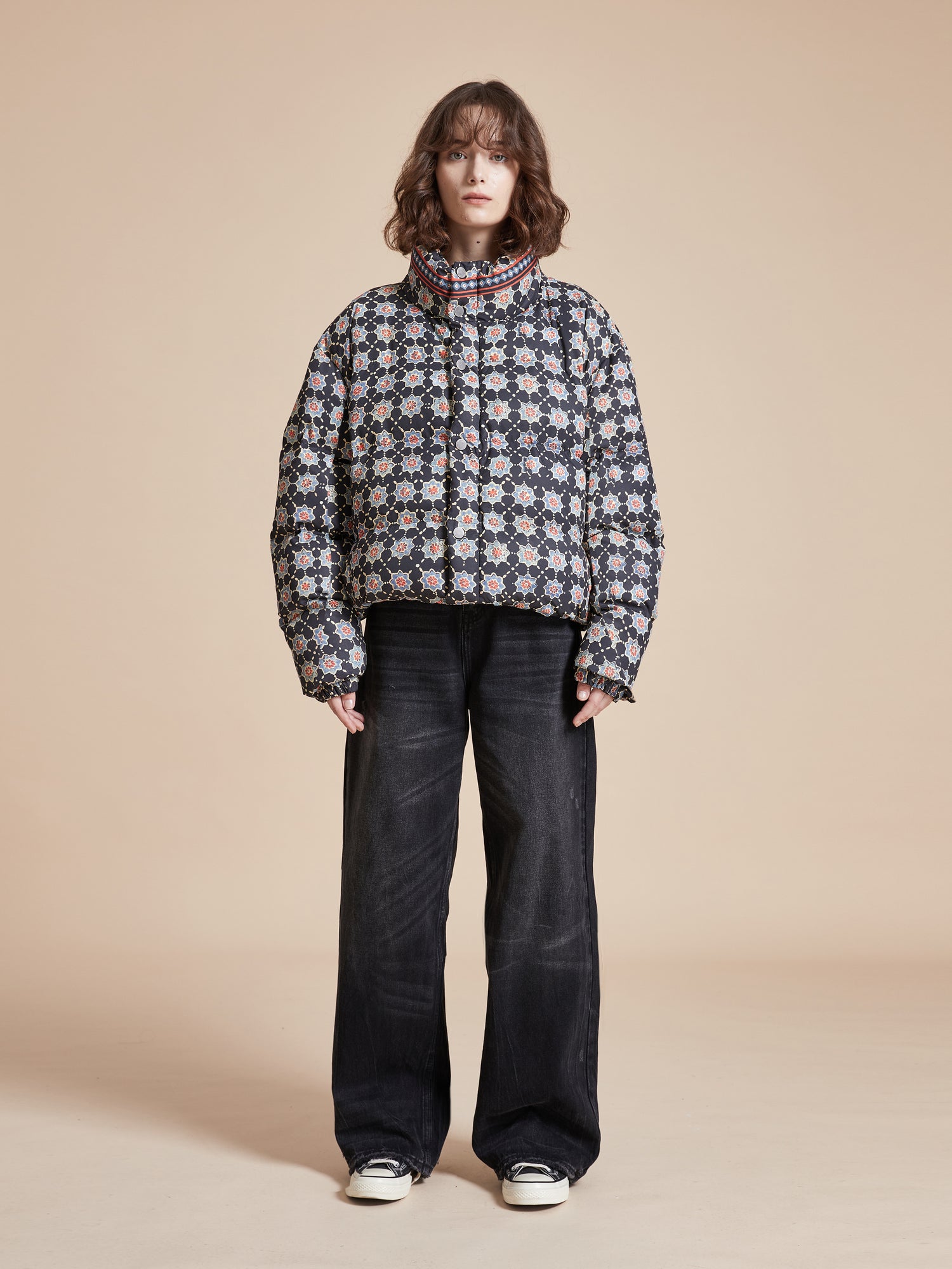 A woman wearing a black Found Ajrak Block Puffer Jacket.