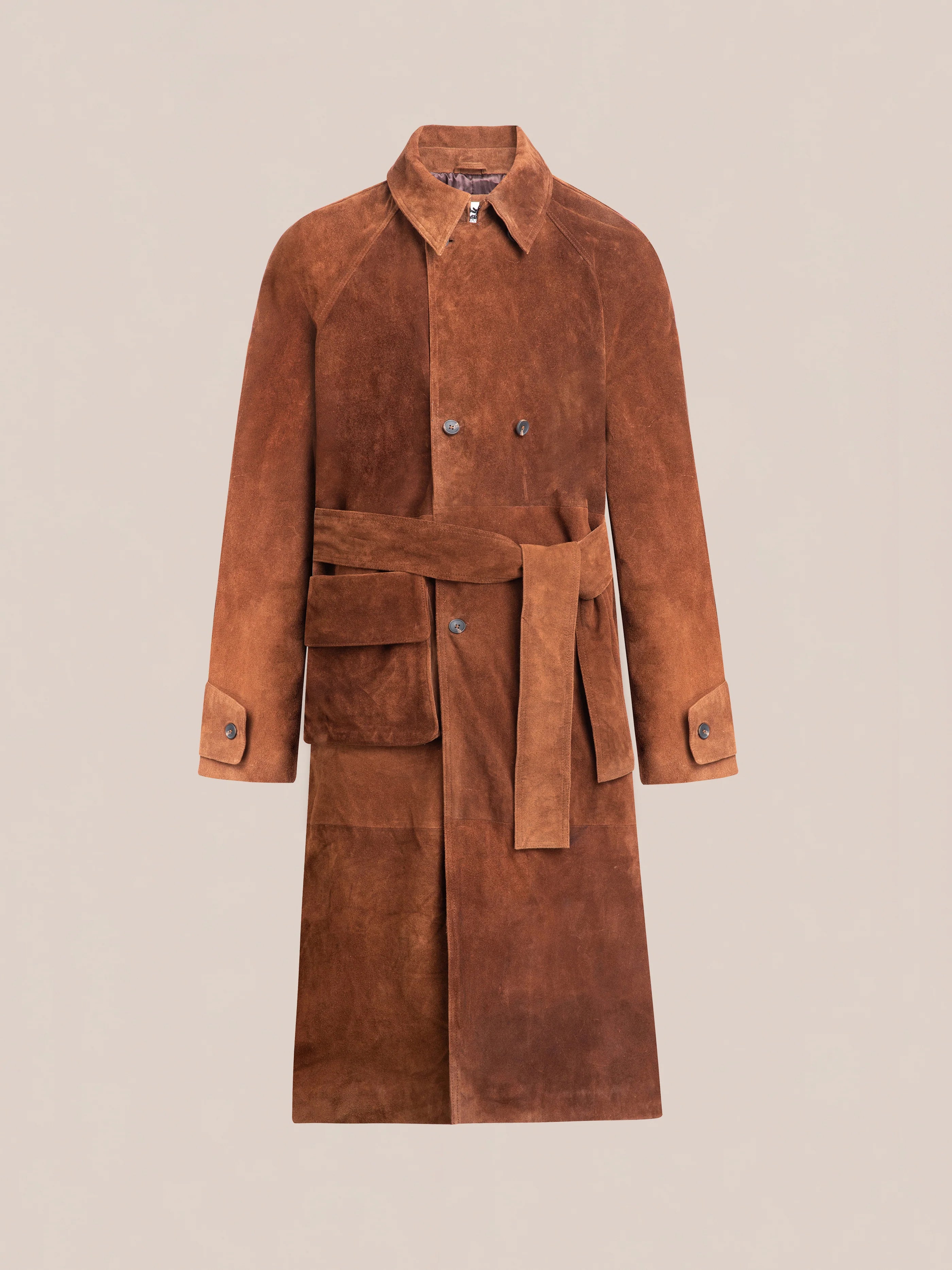 The FOUND Suede Leather Trench Coat boasts luxurious mid-weight cow suede with a belt, buttoned front, wide collar, and large pockets. Its unisex relaxed fit makes it an effortlessly stylish wardrobe choice.