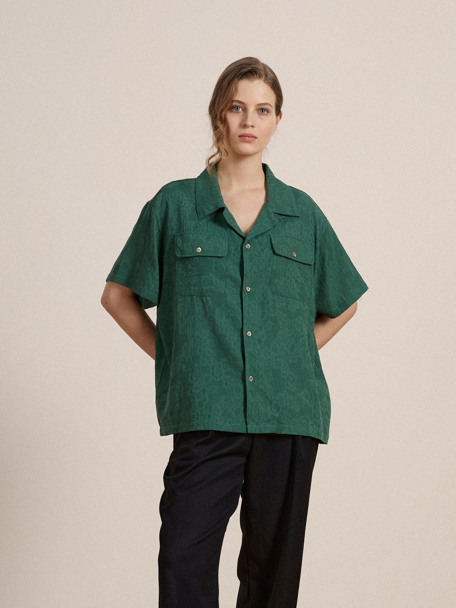 A model wearing a premium cotton Found Mount Camp Shirt with lace detailing and black pants.