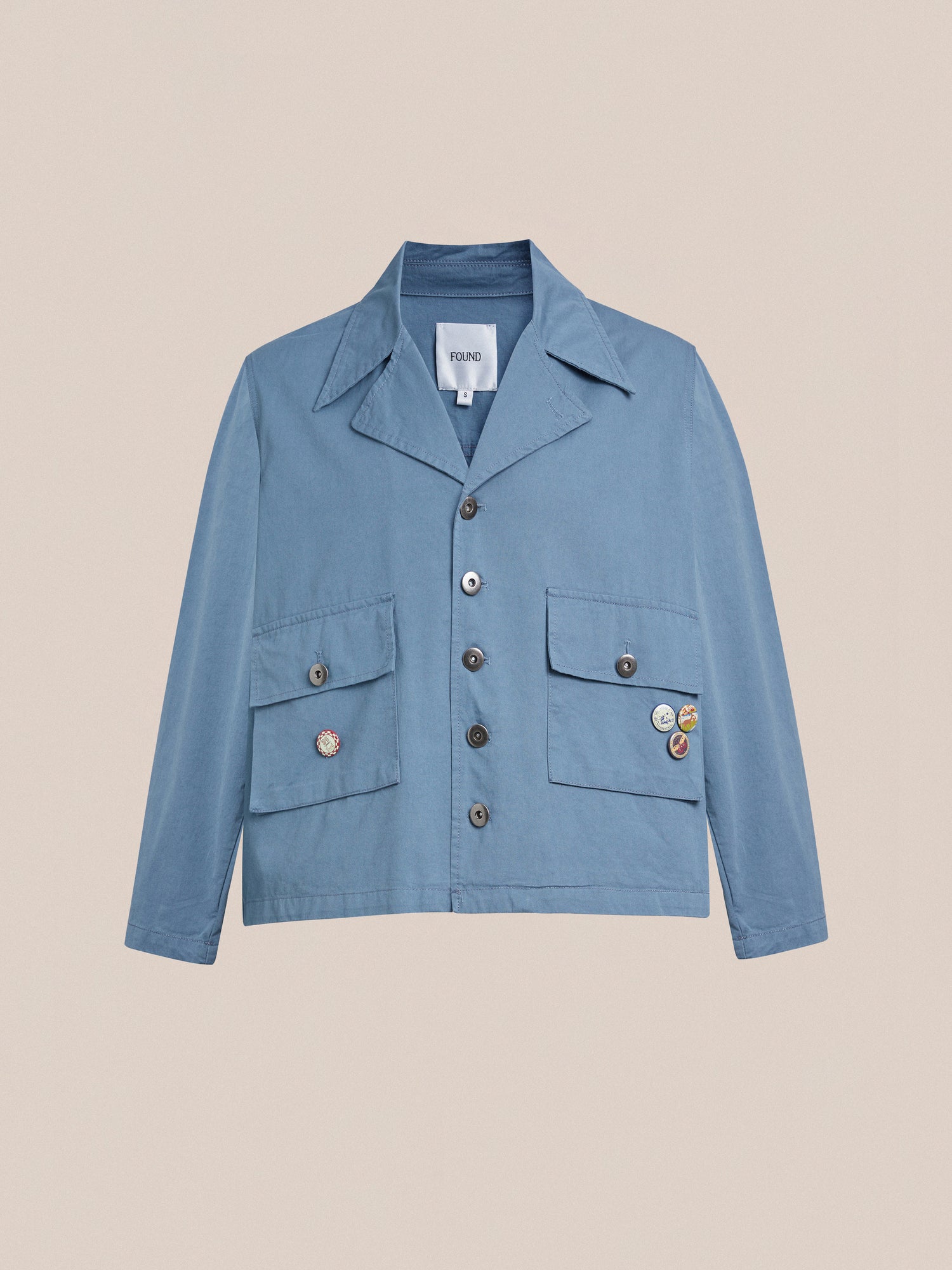 A vintage workwear-inspired Patina Work Jacket with durable buttons on the front by Found.