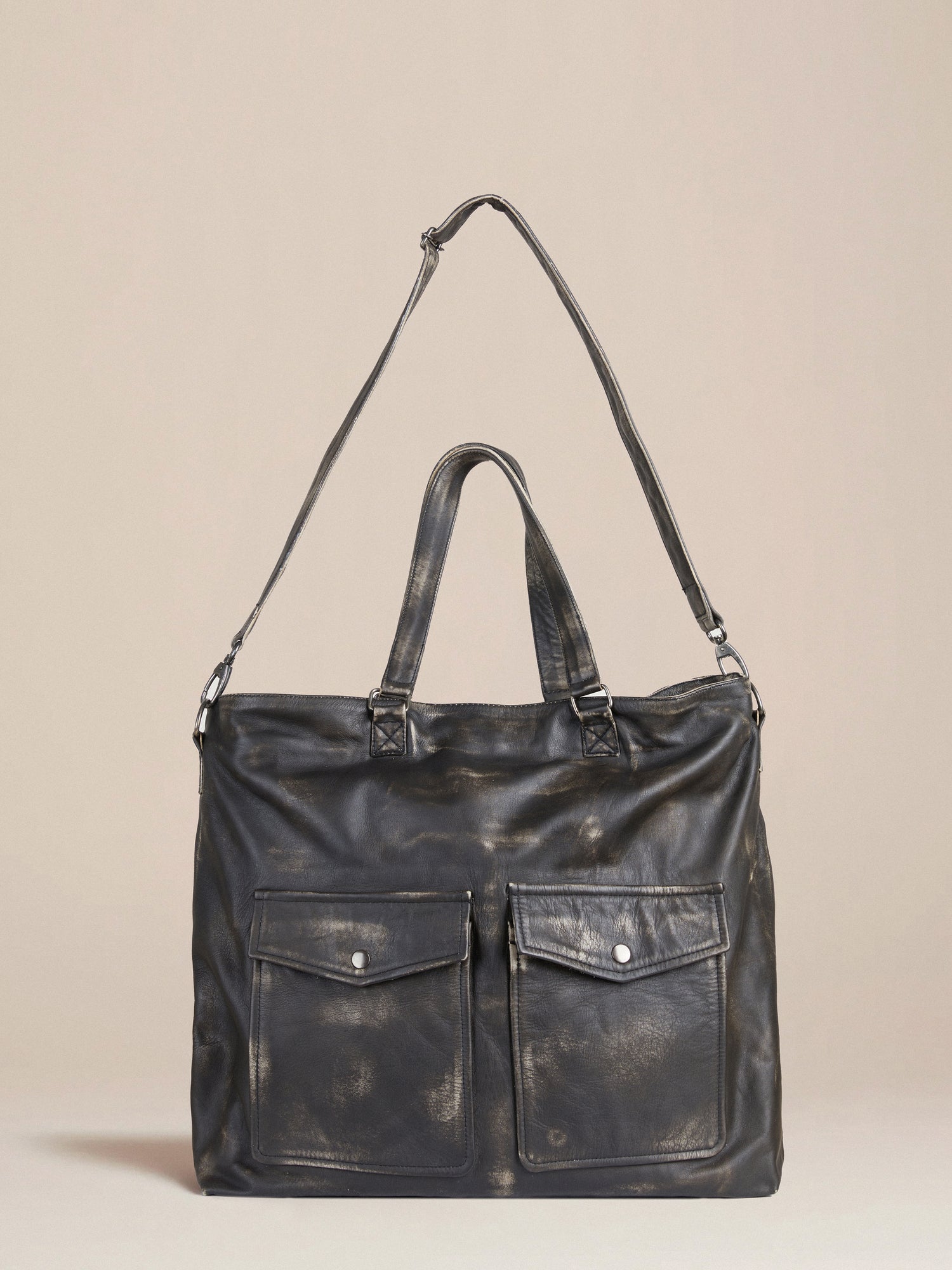 A premium Profound Hana distressed black leather duffel bag with two pockets.