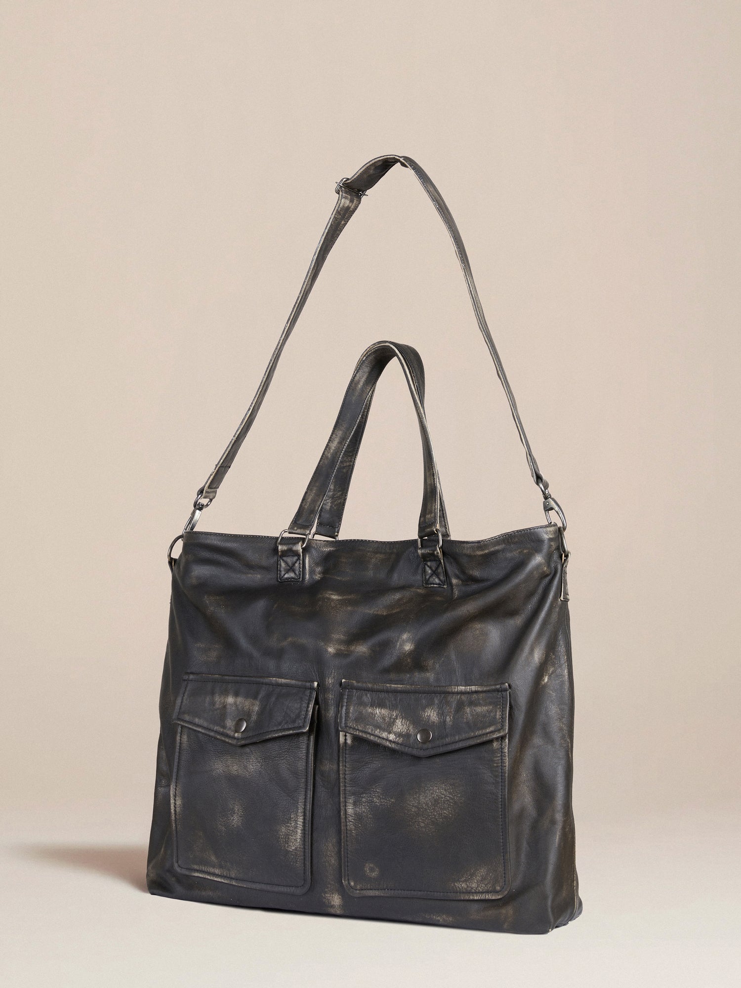 A Profound Hana distressed black leather tote bag with two pockets.