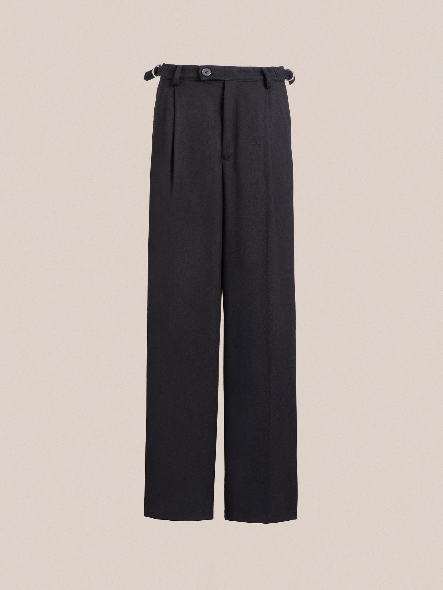 A pair of Found pleated trousers with a belted waist, featuring a relaxed fit.