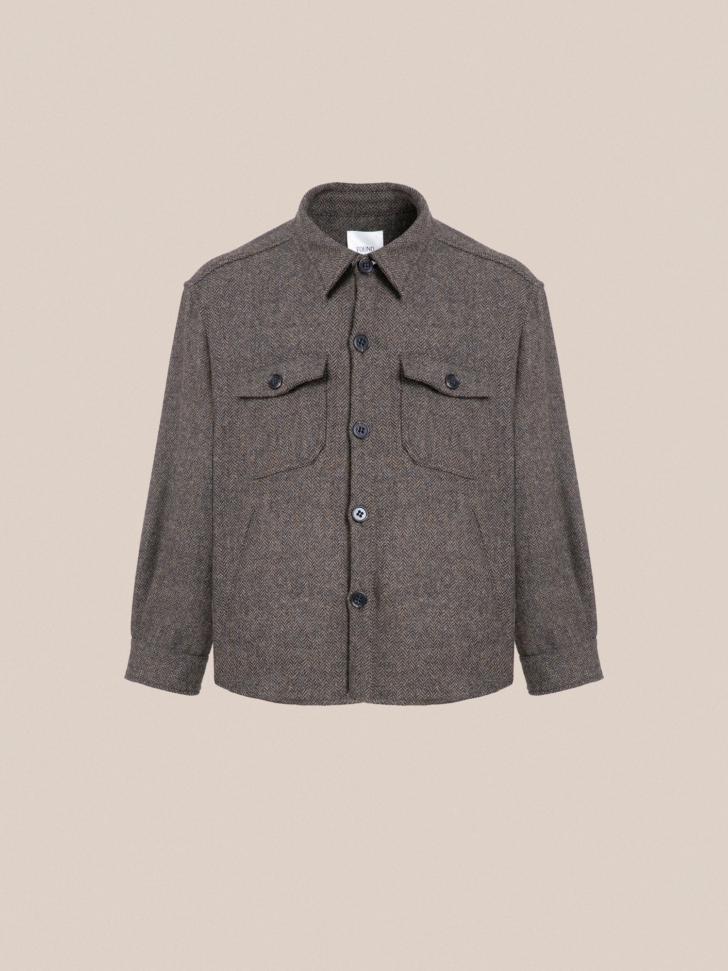 A Raven Herringbone Overshirt with buttons on the front, ideal for layering.