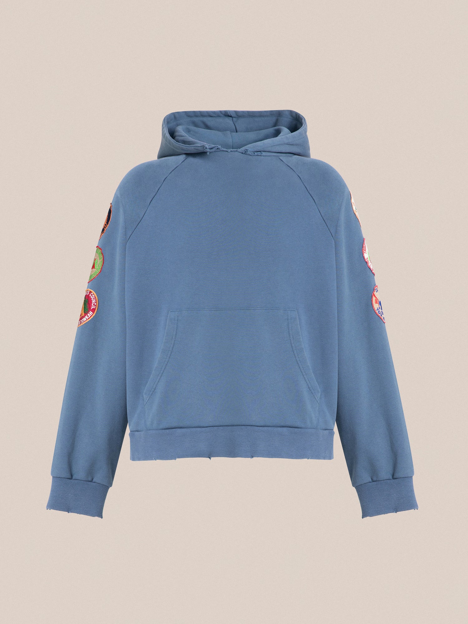 A blue hooded Found Timber Campground Hoodie with embroidered patches and distressed details.