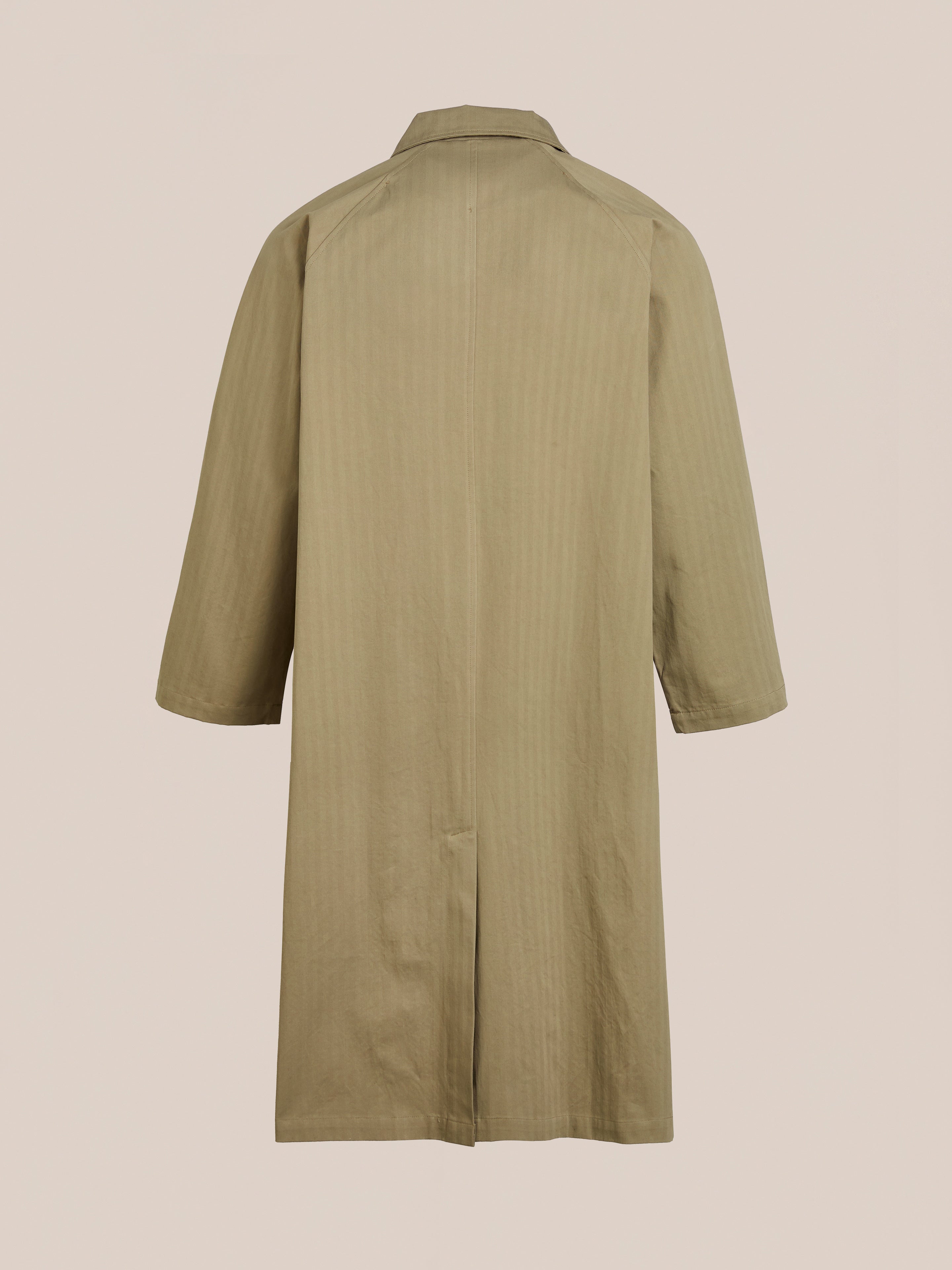 Rear view of FOUND's beige Herringbone Twill Trench Coat, knee-length with a collar and three-quarter sleeves, highlighting its relaxed fit against a plain background.