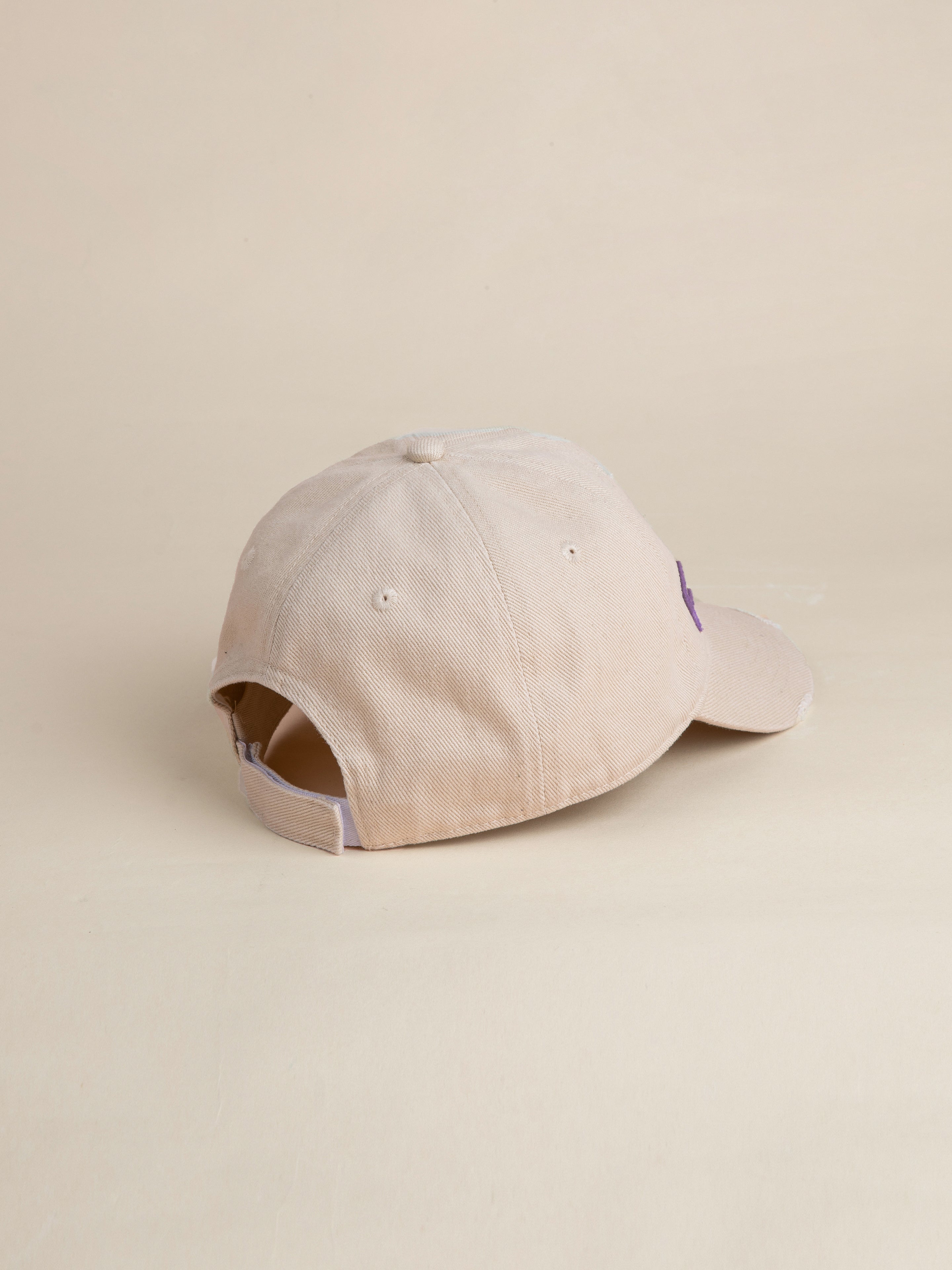 The Ivory Felt Patch Cap by FOUND is displayed from the back, highlighting its adjustable strap and a portion of the brim. The background is plain and light-colored.