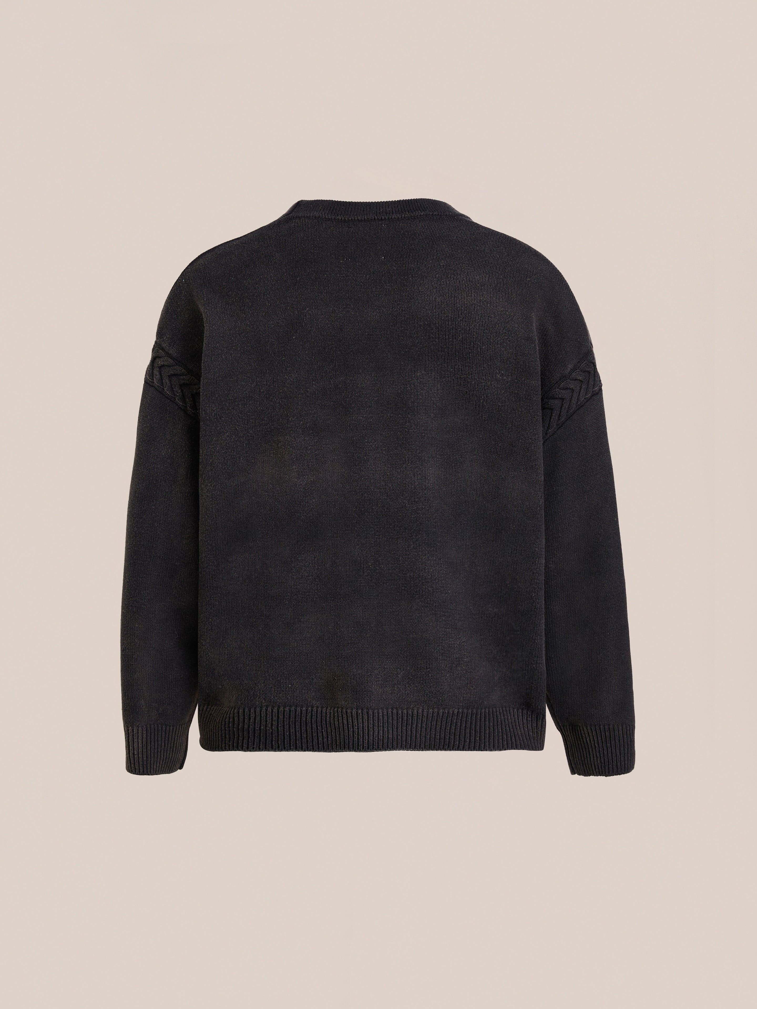 The FOUND Argyle Knit Cardigan is shown from the back on a beige background, featuring ribbed cuffs, hem, and subtle knit detailing on the upper sleeves for a classic, versatile look.