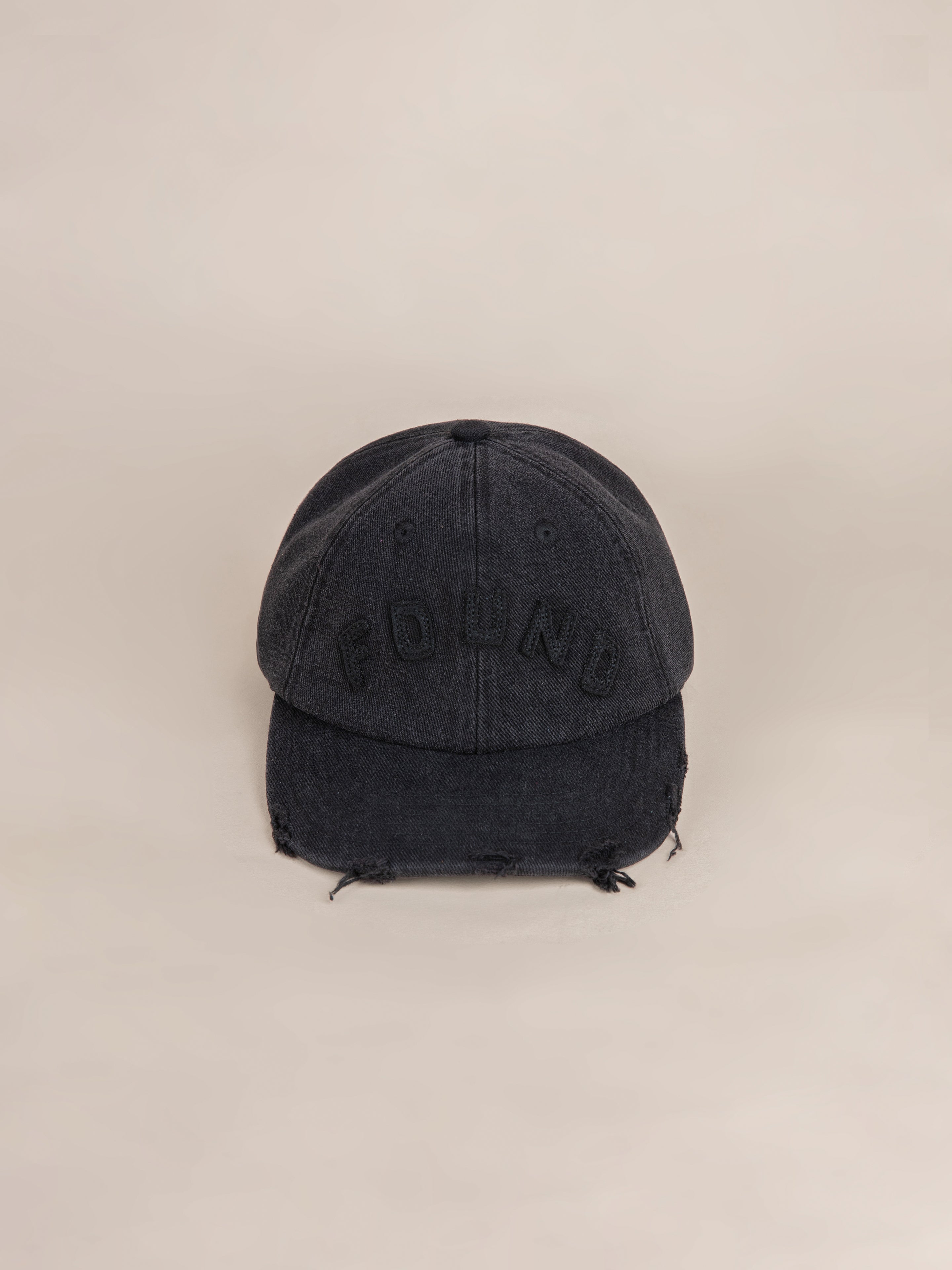 Black Felt Patch Cap from the brand FOUND, featuring a distressed brim for a trendy, worn-in look.