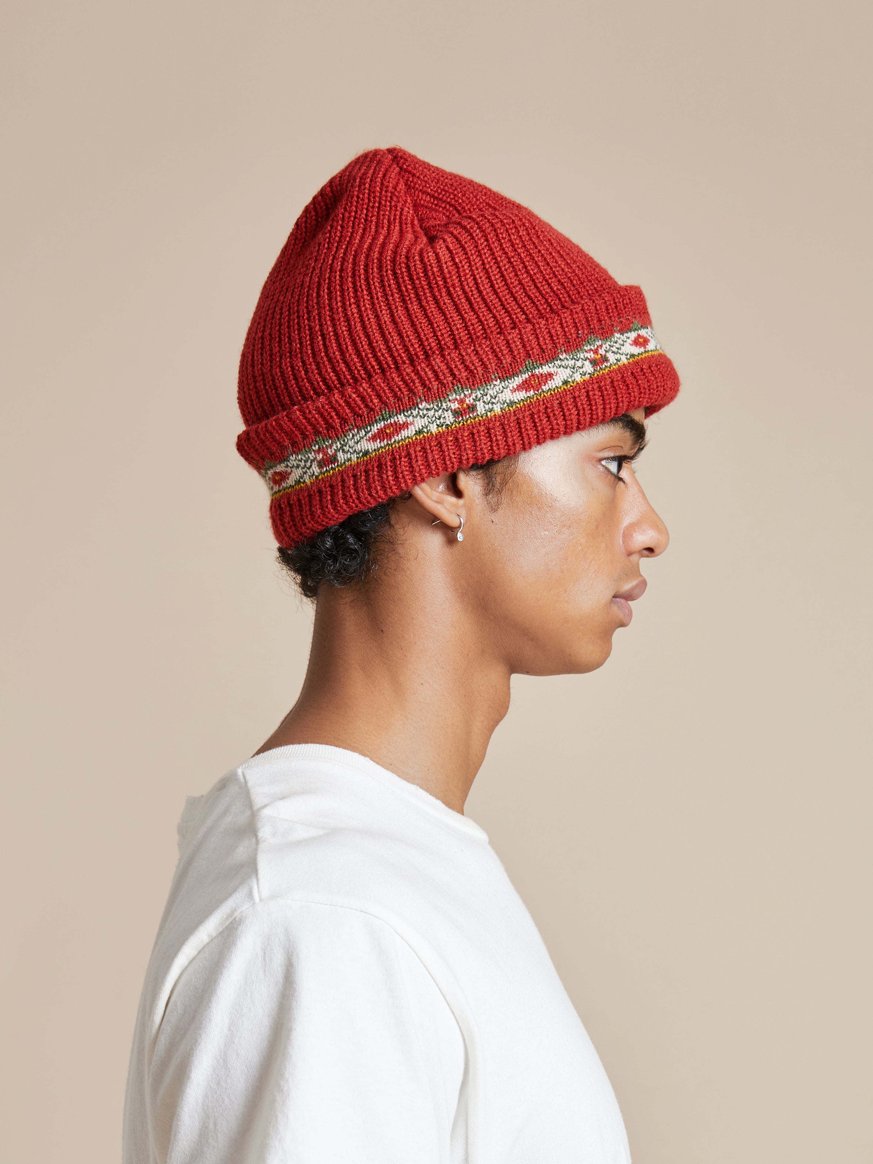 A man wearing a red Profound Ajrak beanie.