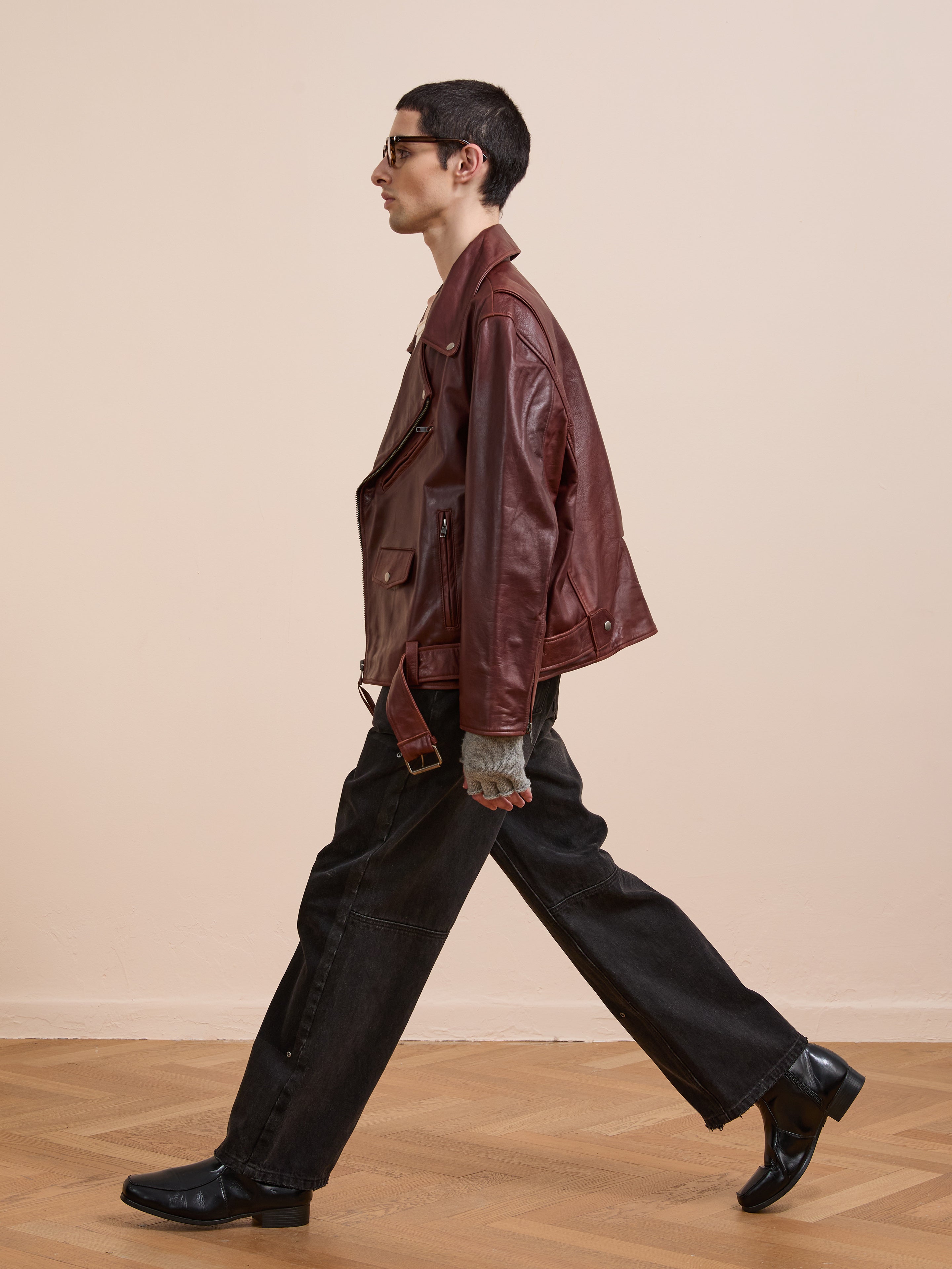 A man walking in the FOUND Leather Biker Jacket.