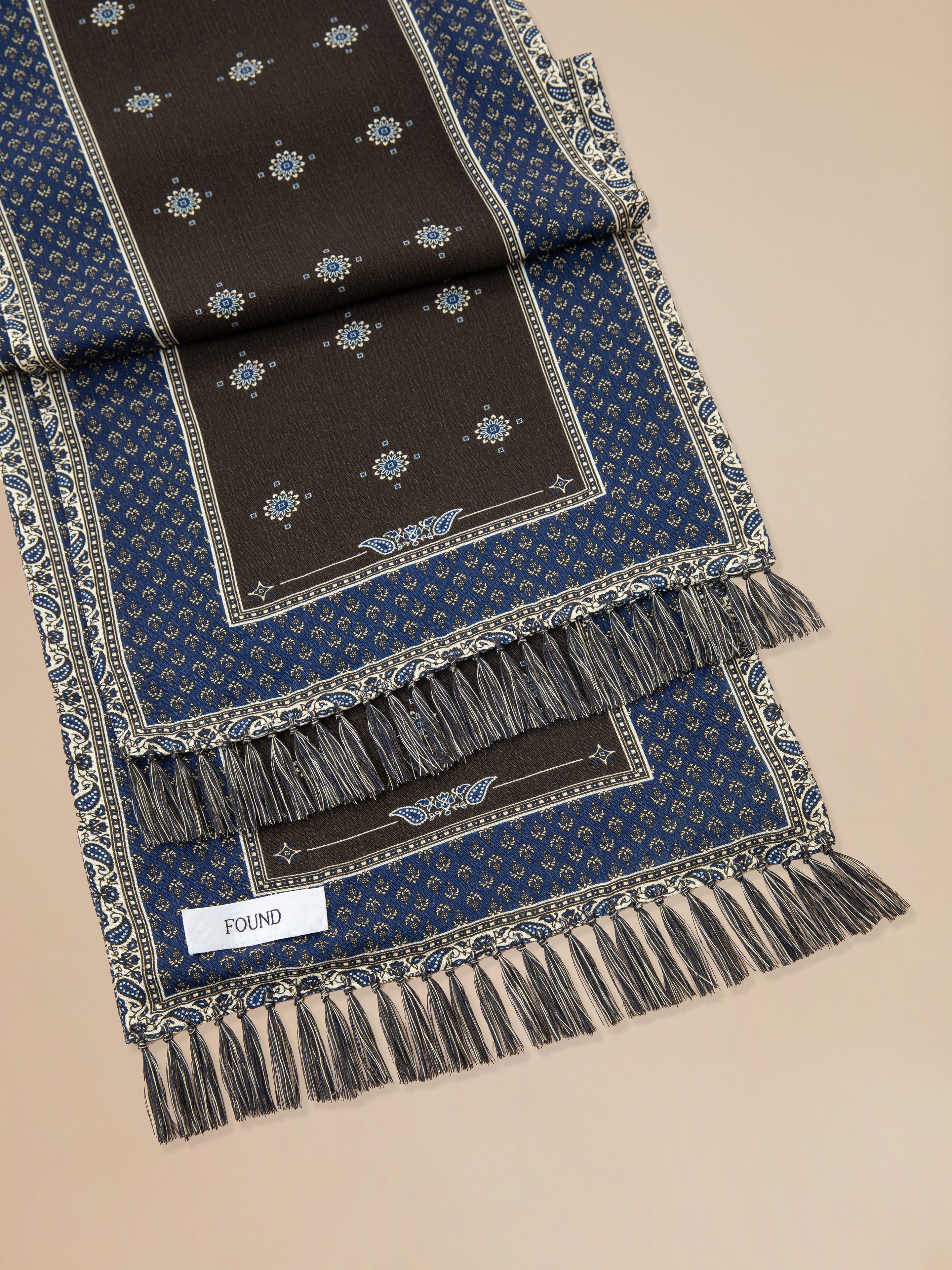 A close up of a Found Black Royal Blue Print Scarf.