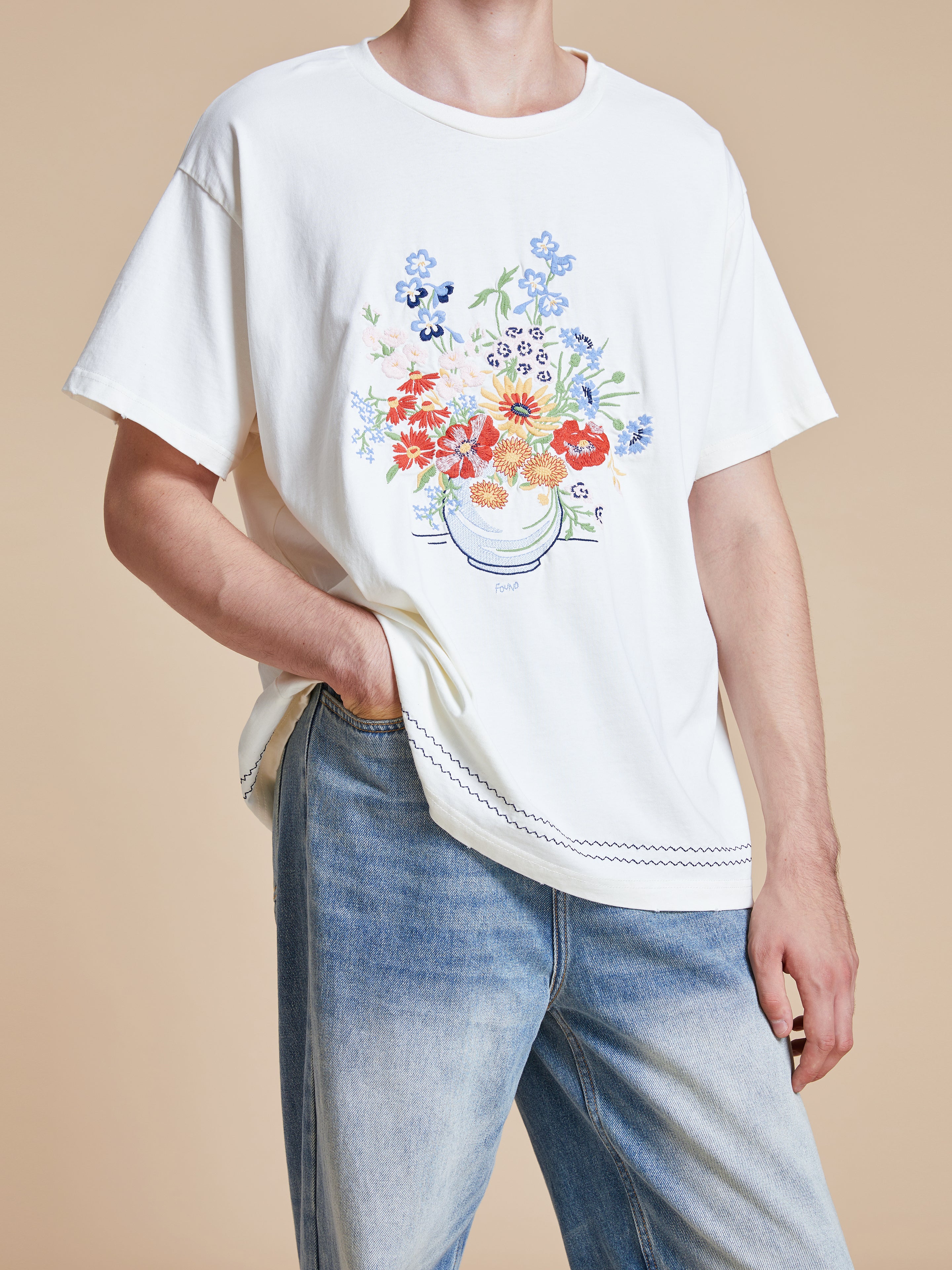 A man wearing a Found Bouquet Flowers Tee.