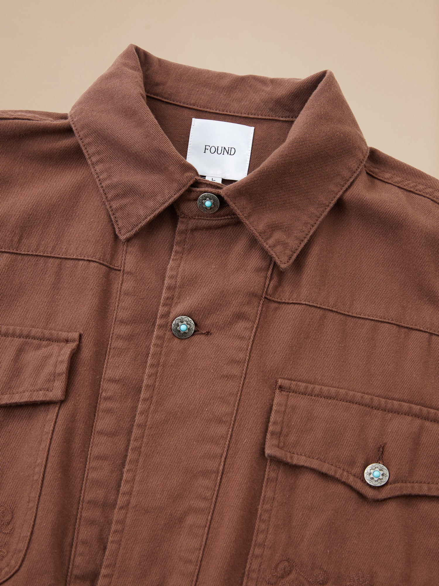 A Dusky Western Trucker Jacket by Found with buttons and pockets.