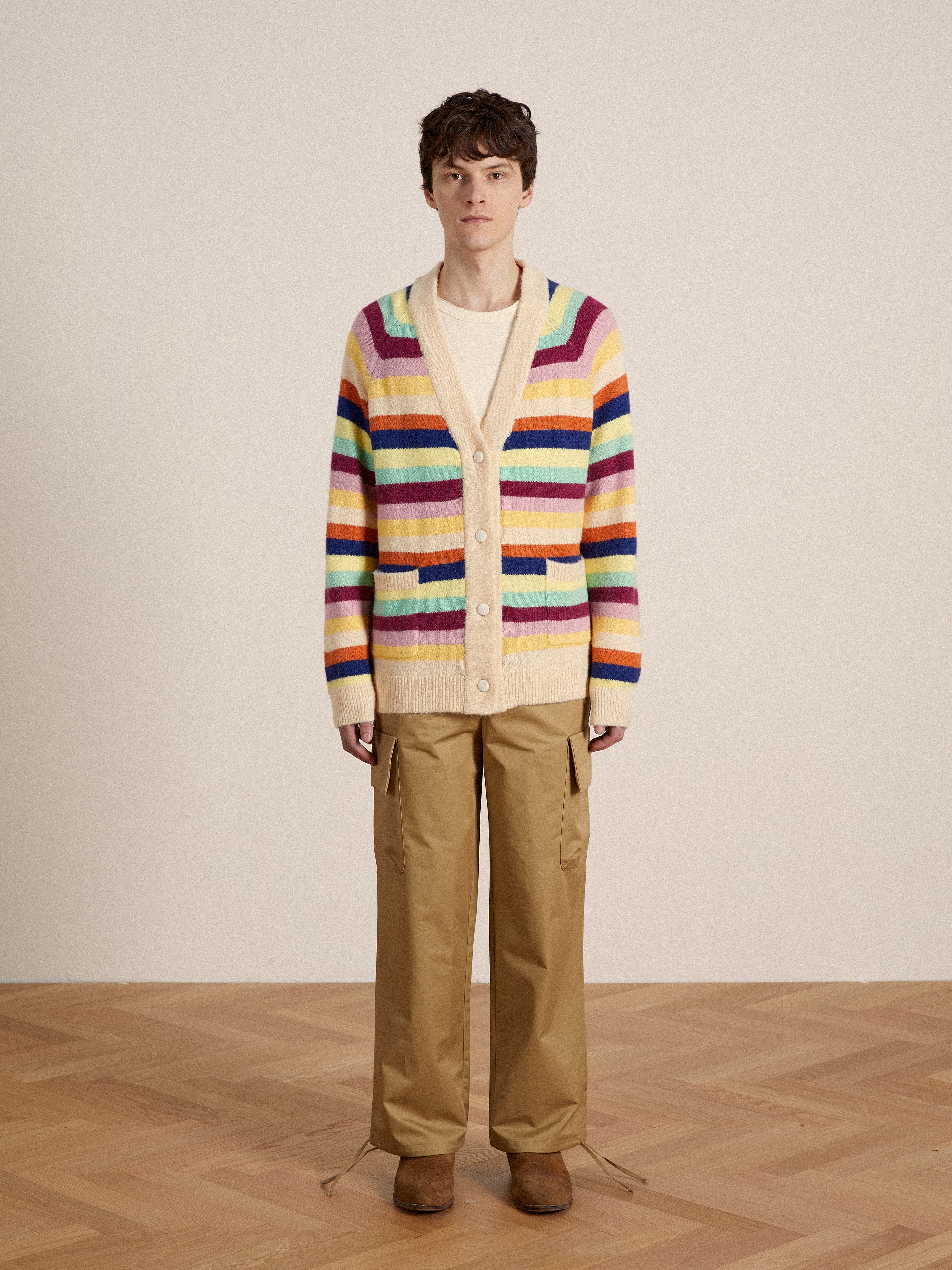 A man in a vibrant-hued Found Razi Multi Stripe Cardigan.