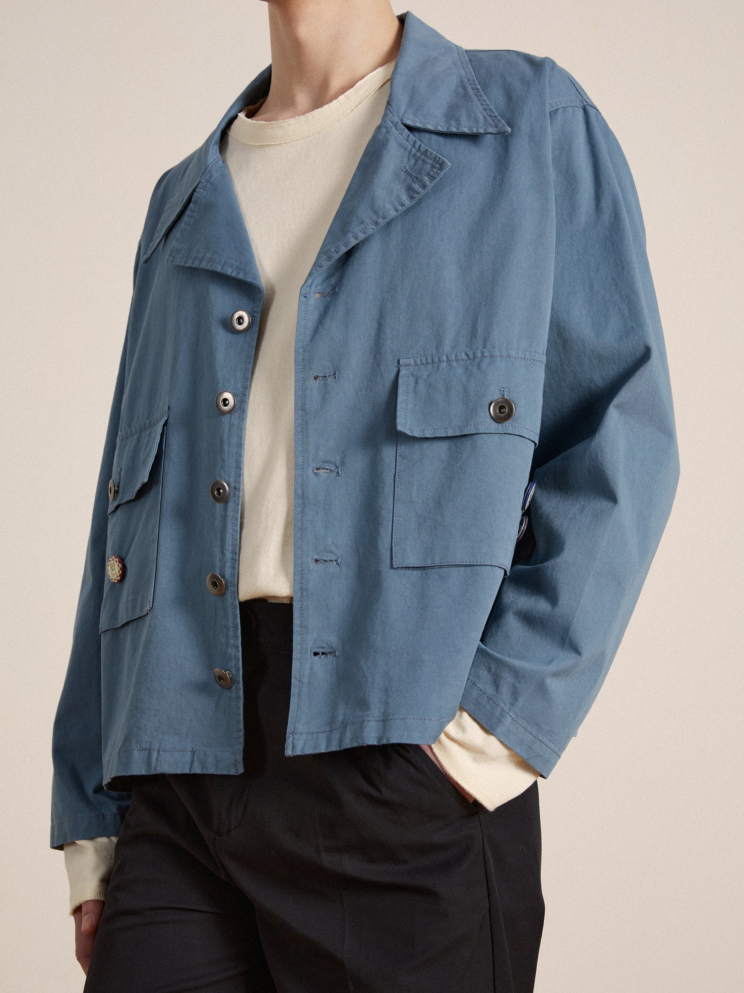 The model is wearing a blue Found Patina Work Jacket with buttons.