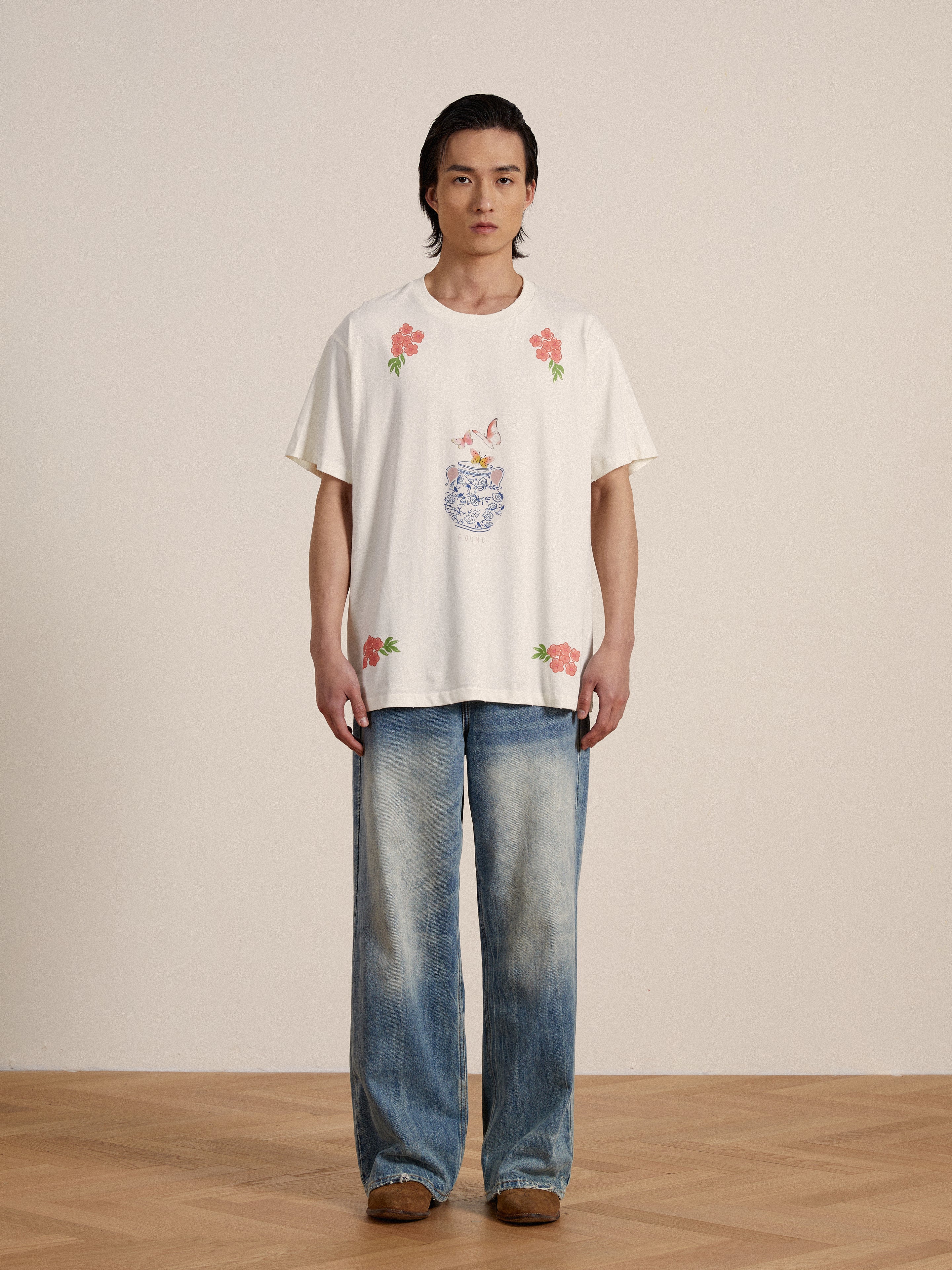 A man wearing a Found Flower Pot Tee and jeans.