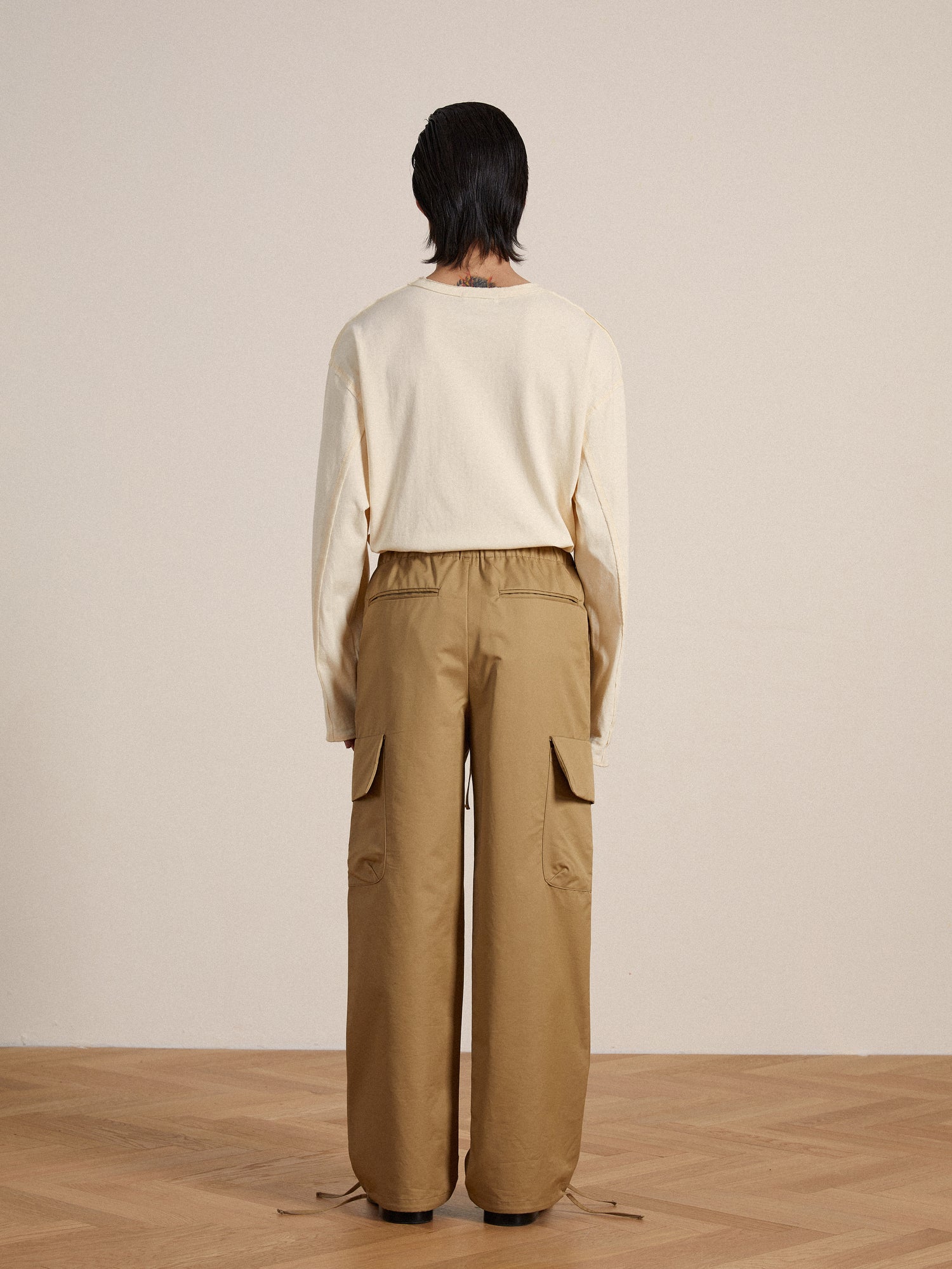 The back view of a woman wearing Found Twill Cargo Drawstring Pants.